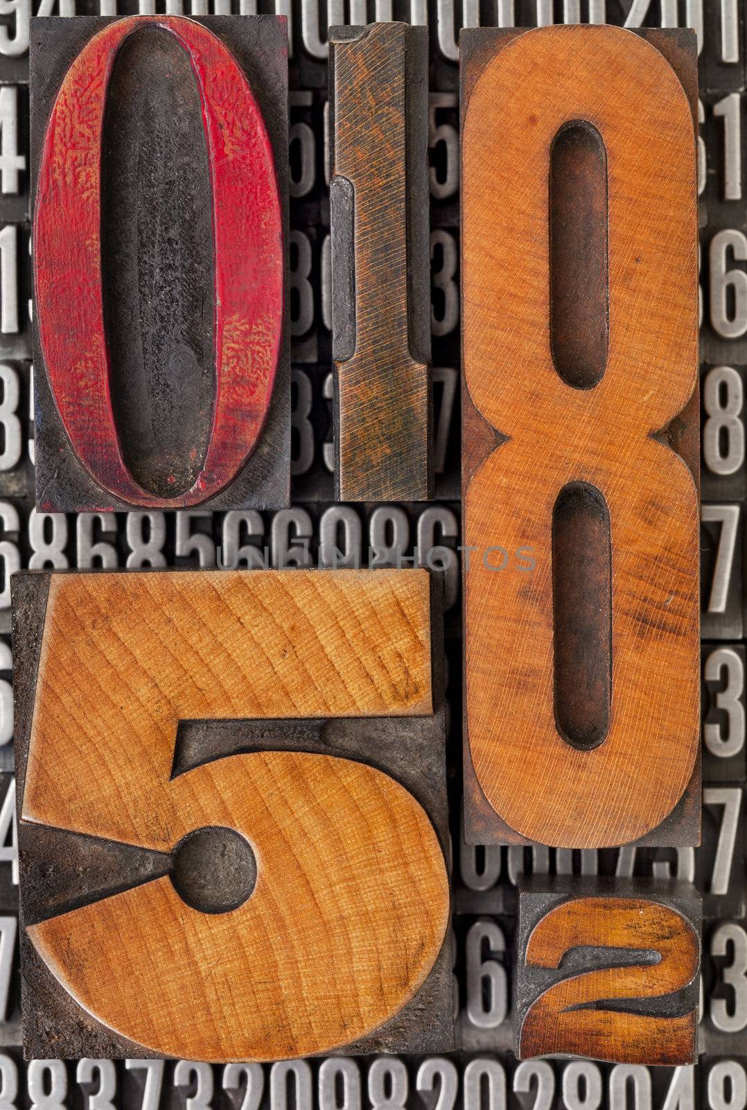 number abstract - vintage  letterpress wood type stained by color ink over metal typeset
