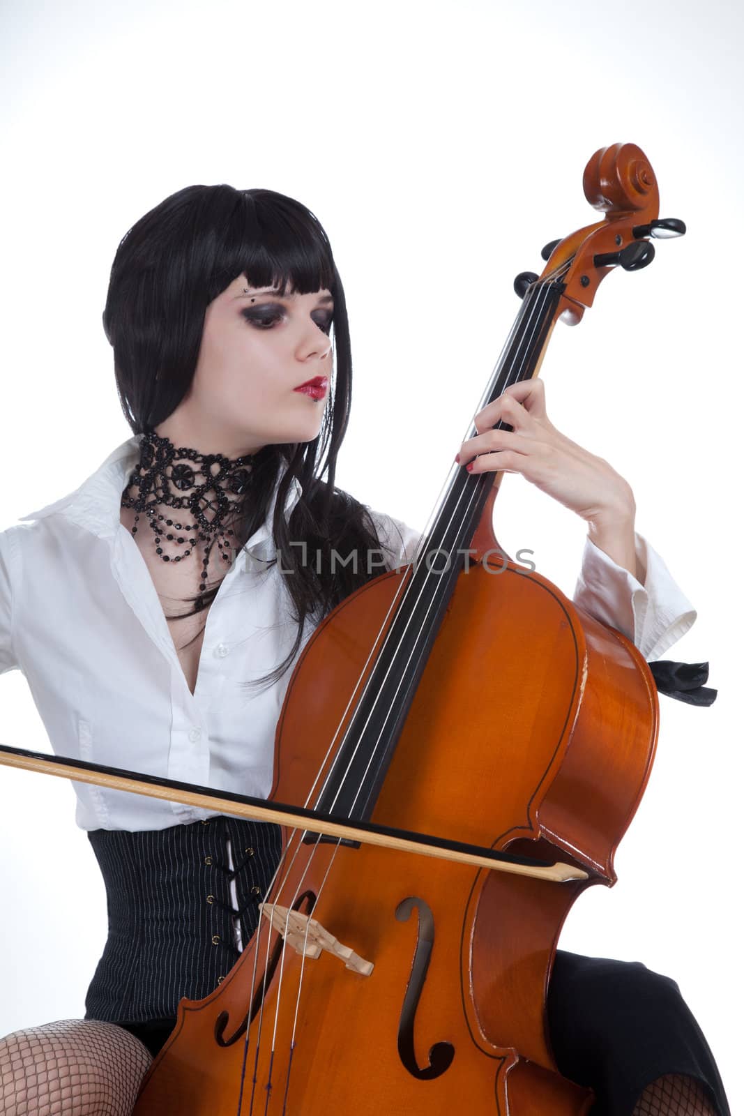 Attractive girl playing cello, studio shot over white background 