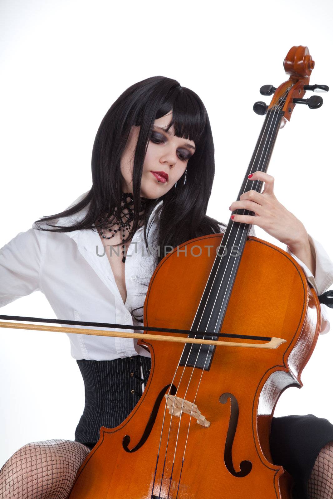 Romantic girl playing cello, studio shot over white background 