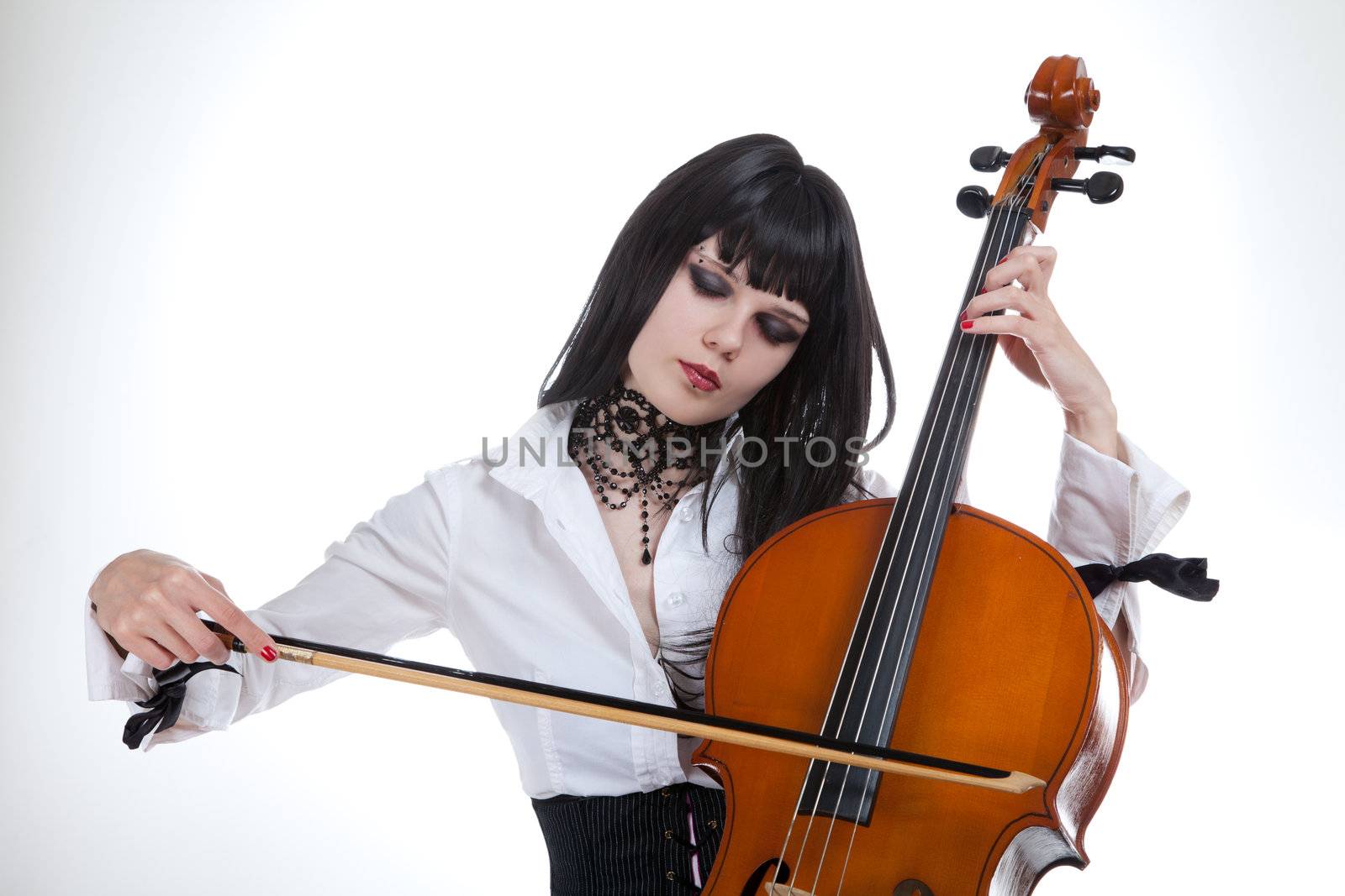 Portrait of attractive girl playing cello, studio shot over white background 