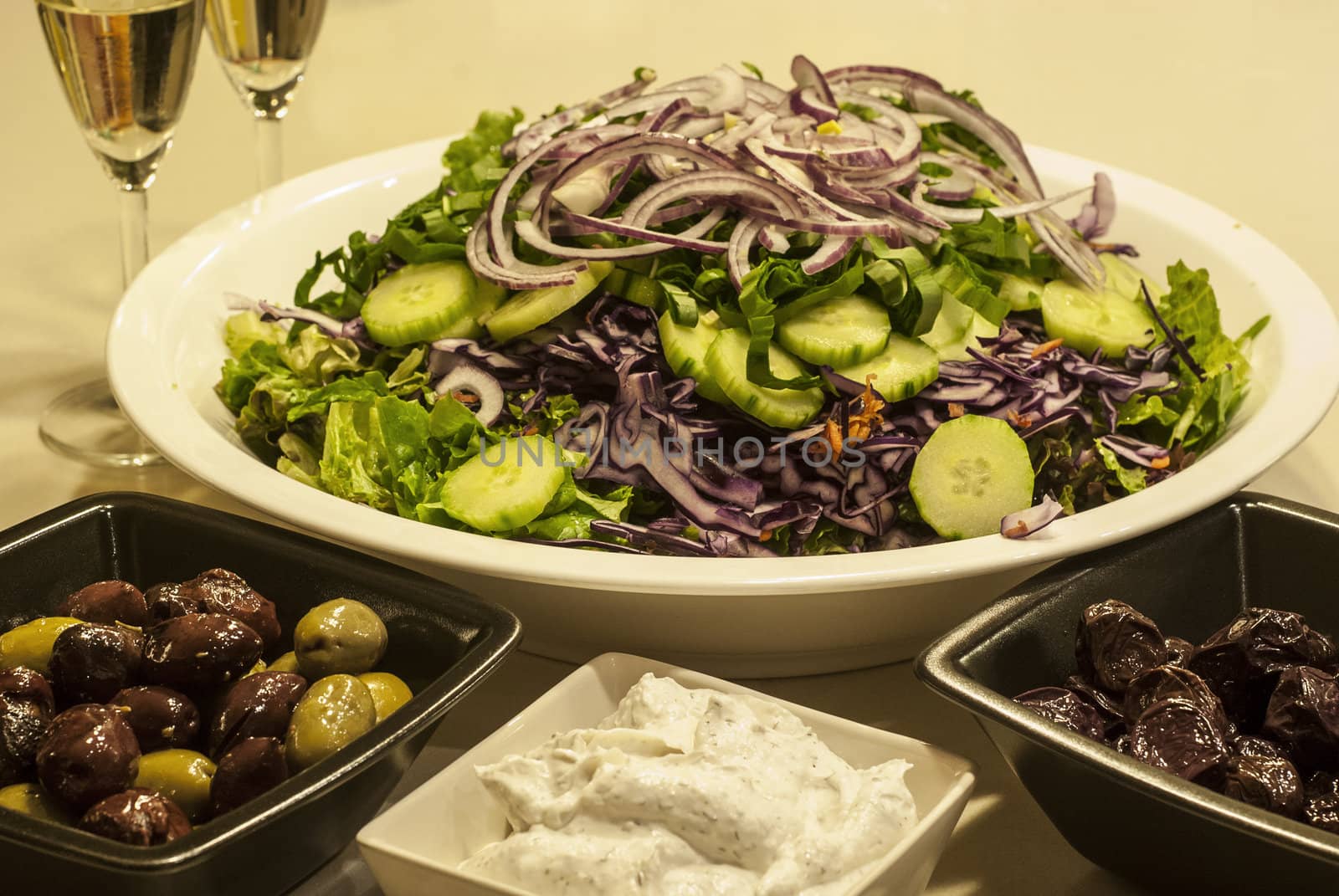 Salad dish, olives, caviar,white wine glasses