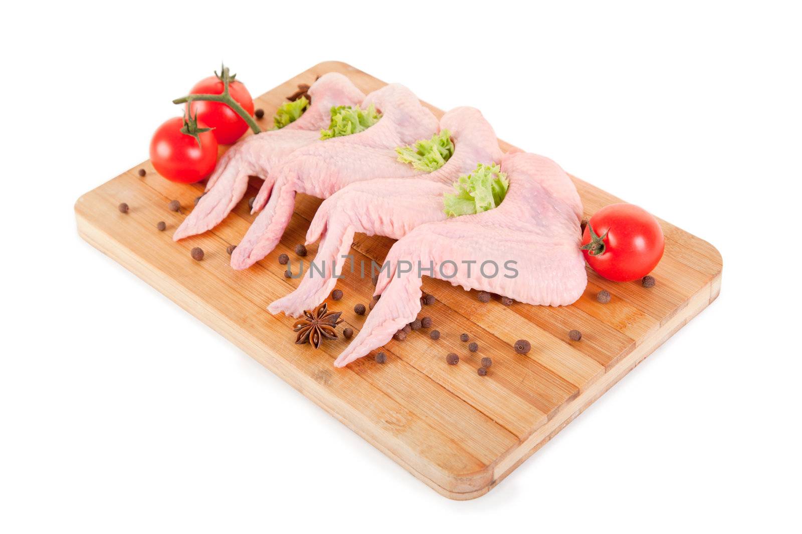 Raw chicken wings with condiments, clipping path included 