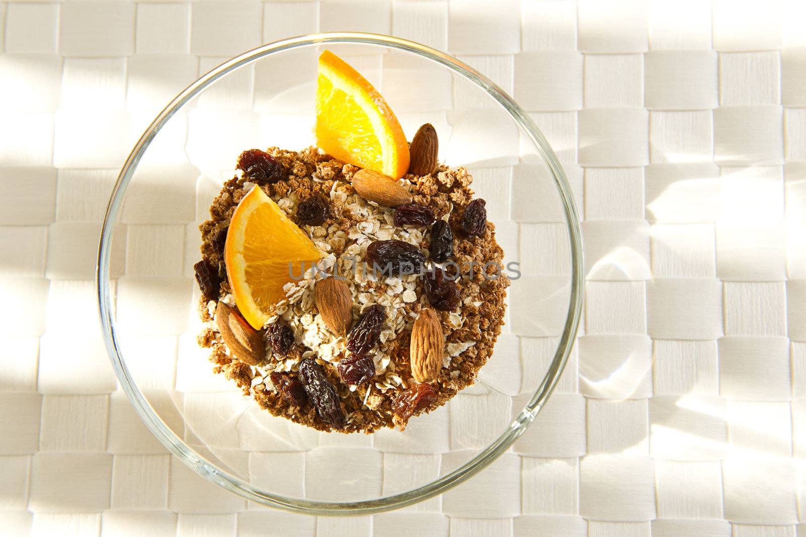 Healthy bowl of muesli with orange slices.