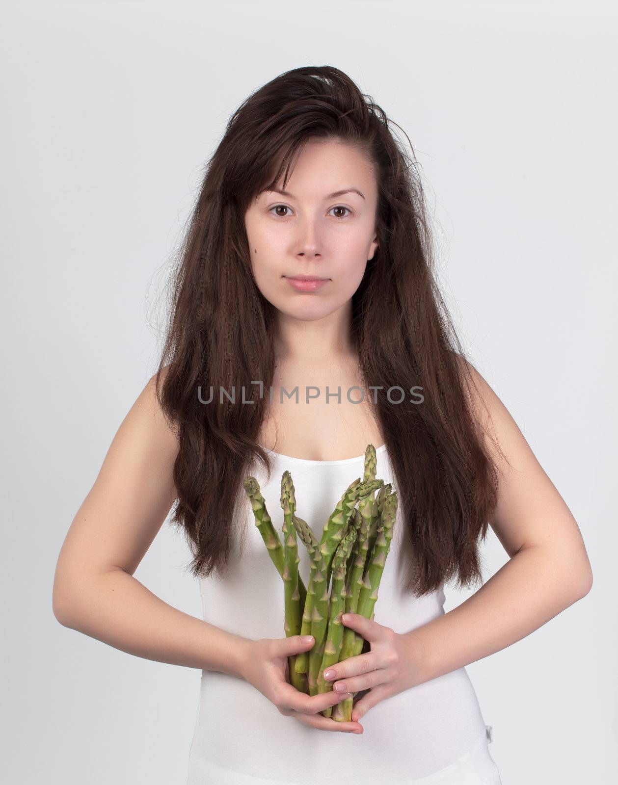 The young beautiful woman with the fresh vegetables by Discovod