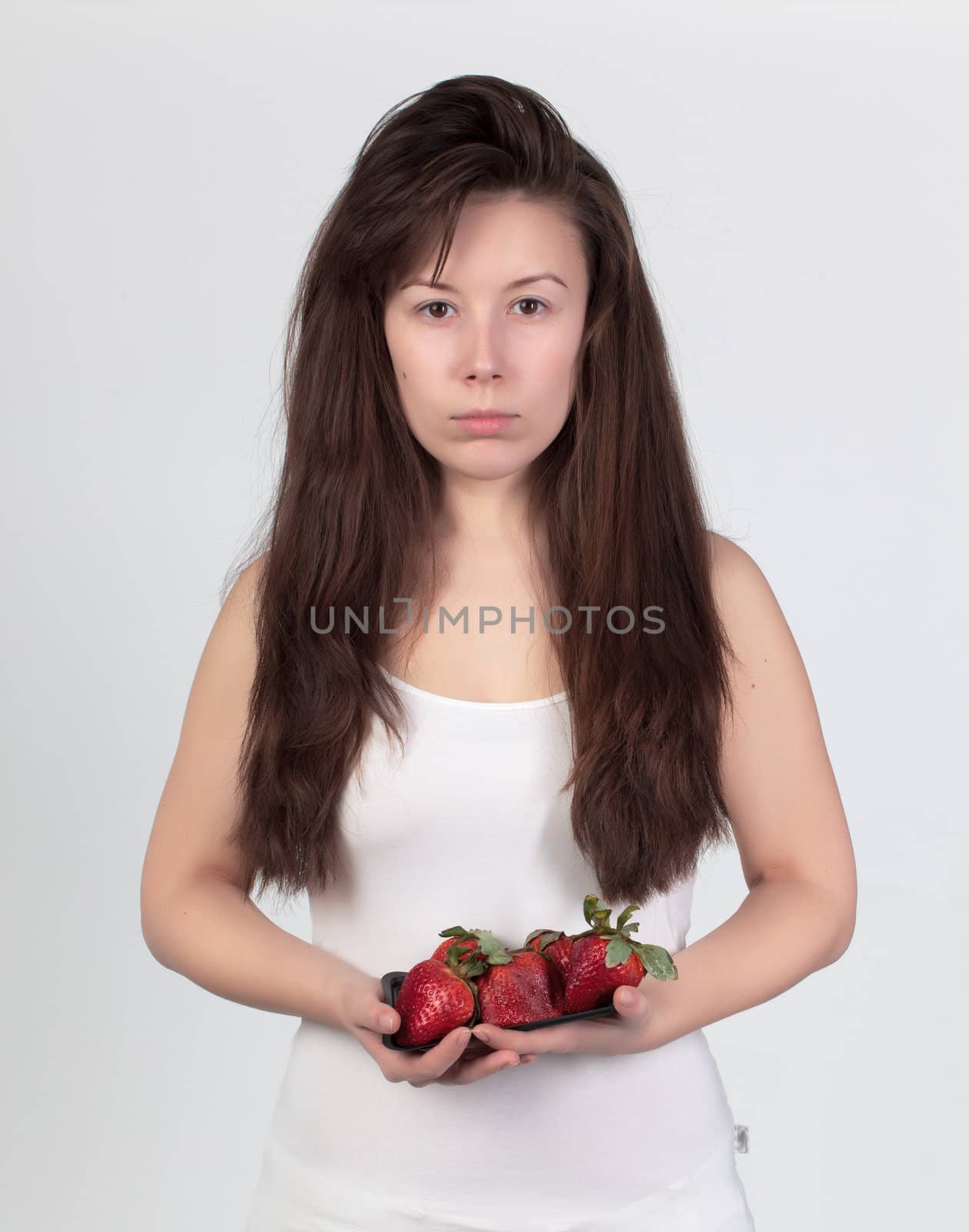 The young beautiful woman with the fresh strawberries by Discovod