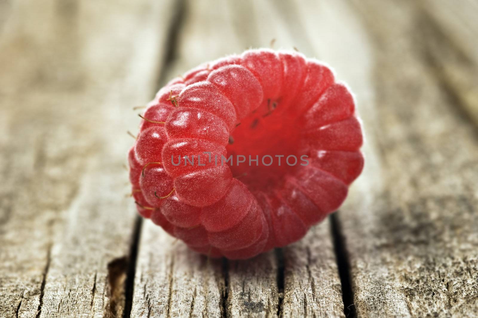 Fresh healthy organic raspberry on wooden background by tish1