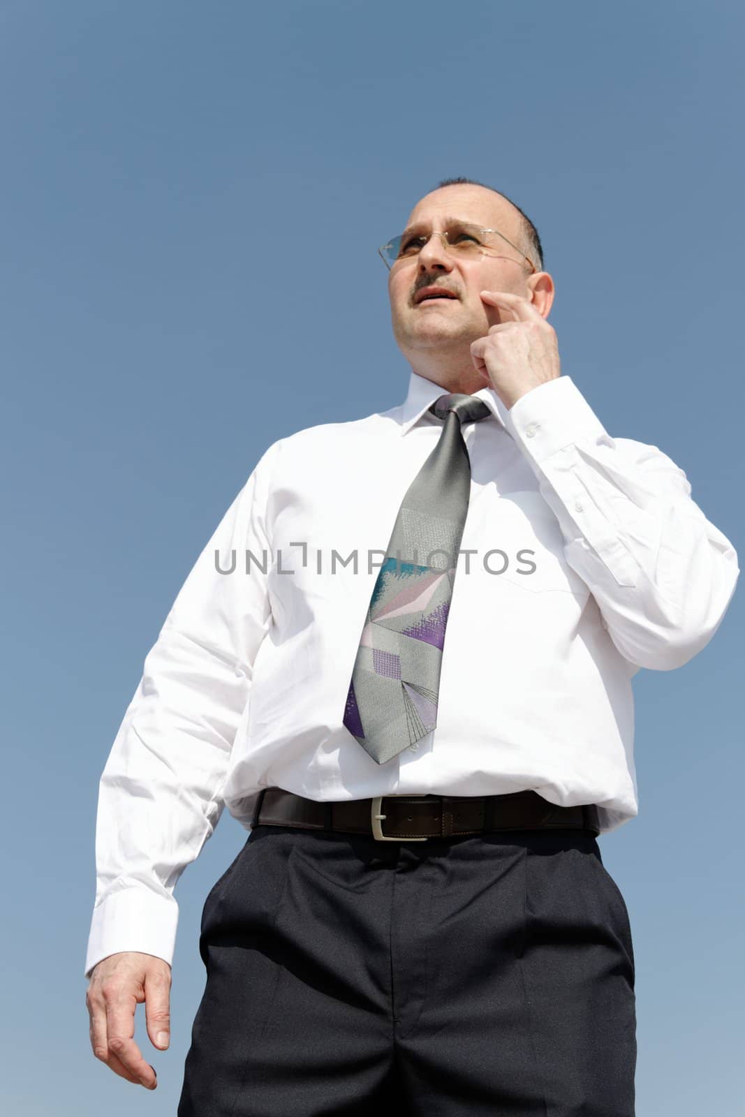 thoughtful businessman with sunglasses and beart
