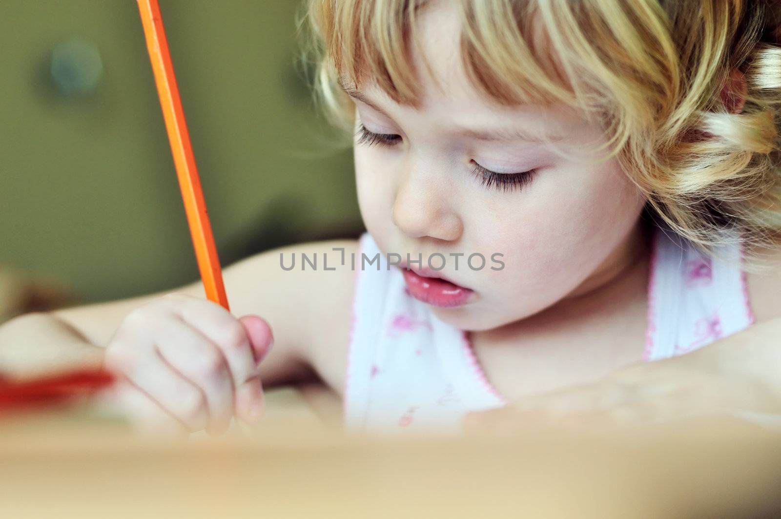 serious little girl drawing in soft selective focus 