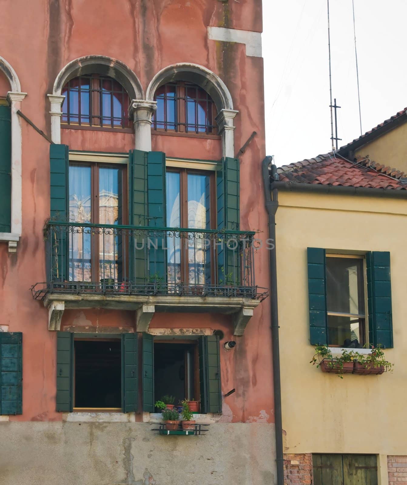 The facade of the old house in Venice with beautiful windows
