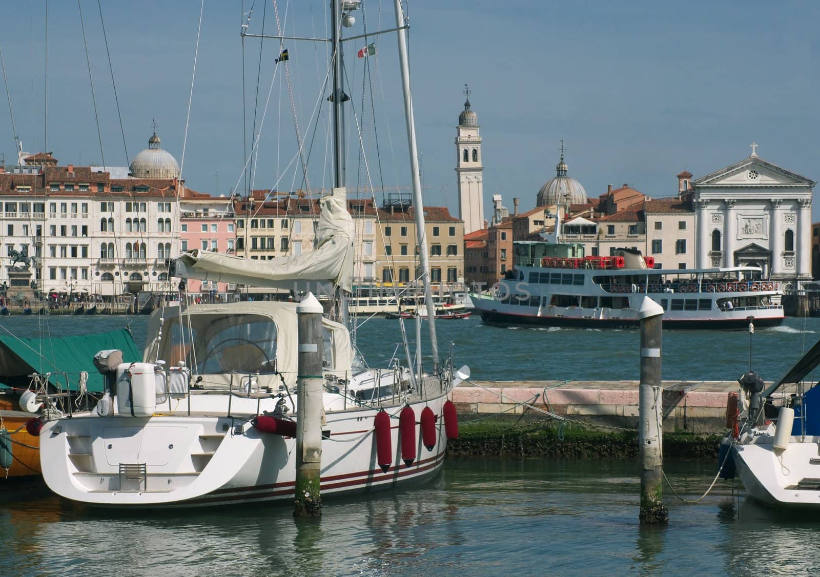 View of Venice from the Island of San Giorgio at the Schiavoni promenade with the yacht in the foreground