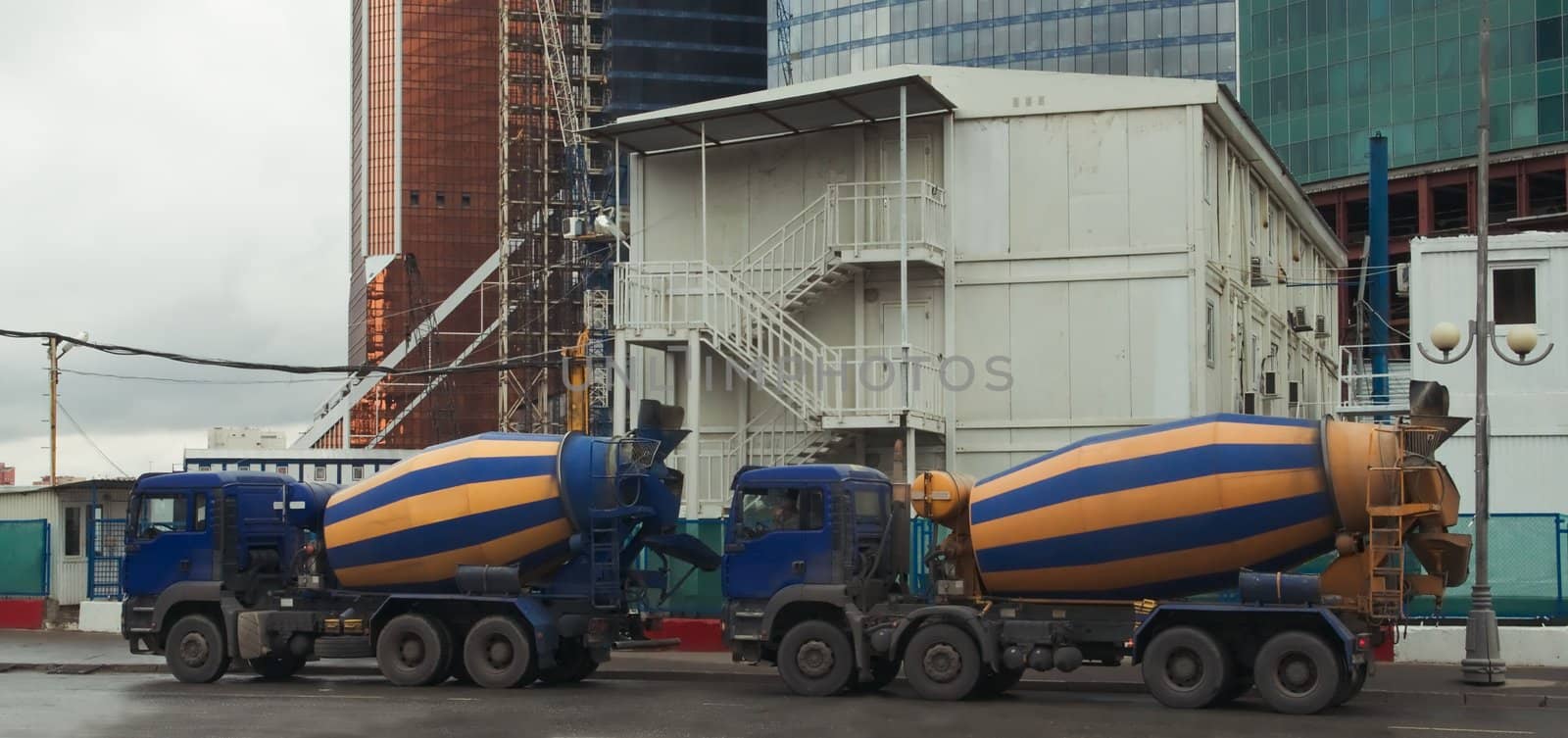 Two mixers concrete trucks at a construction site in Moscow