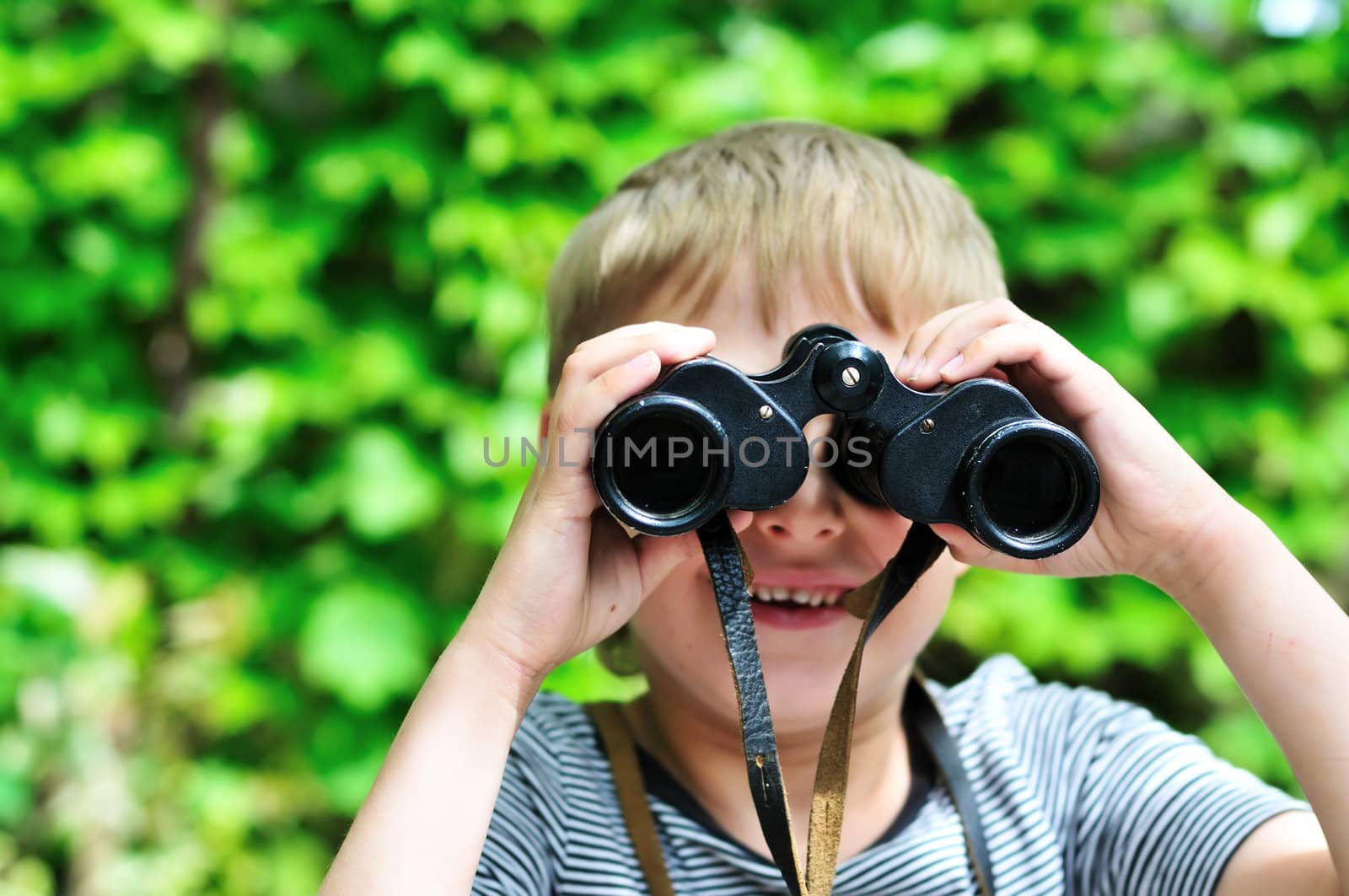 Boy looking through binocular in selective focus