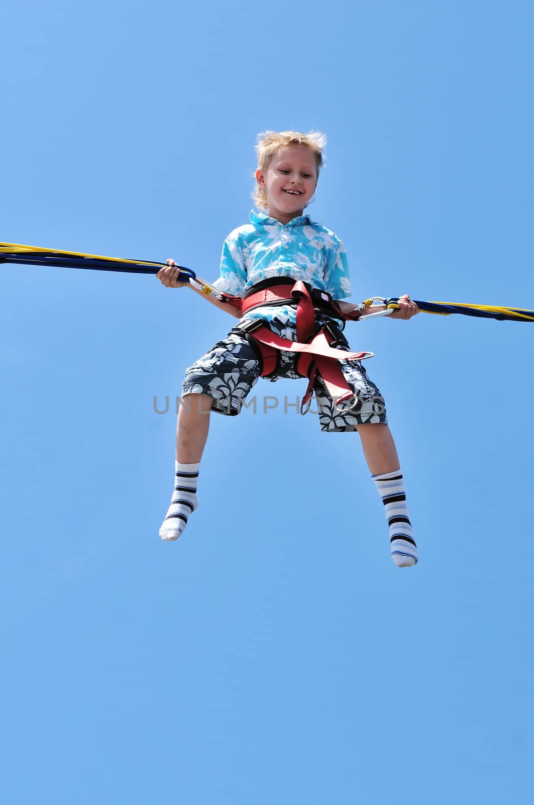 happy little boy flying over the blue sky