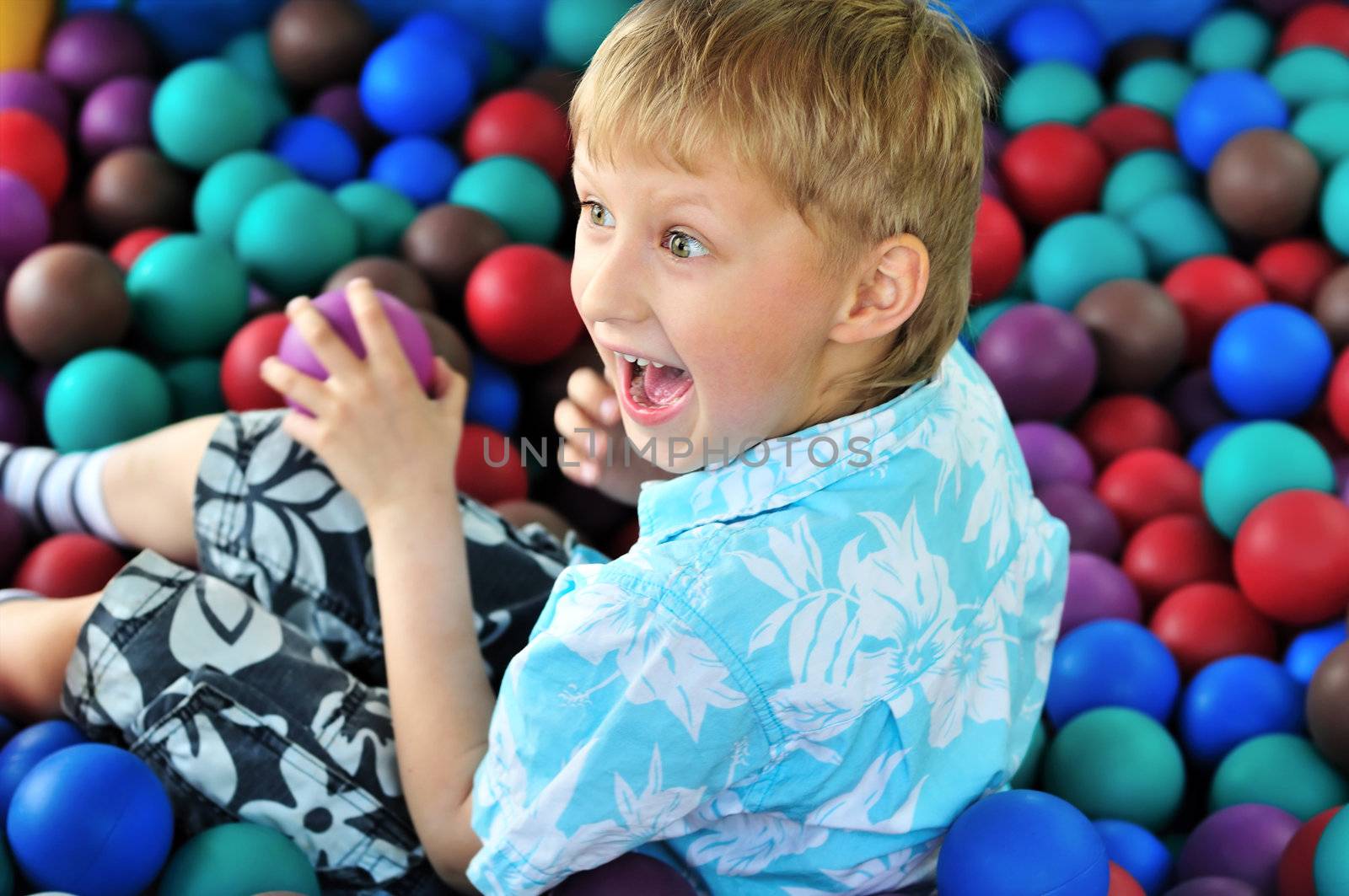 boy playing with balls in the theme park