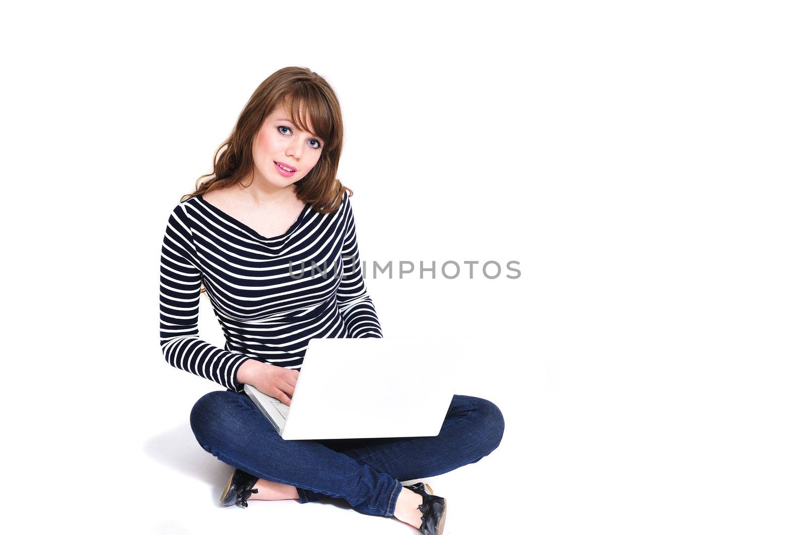 student girl working on laptop and sitting on the floor 