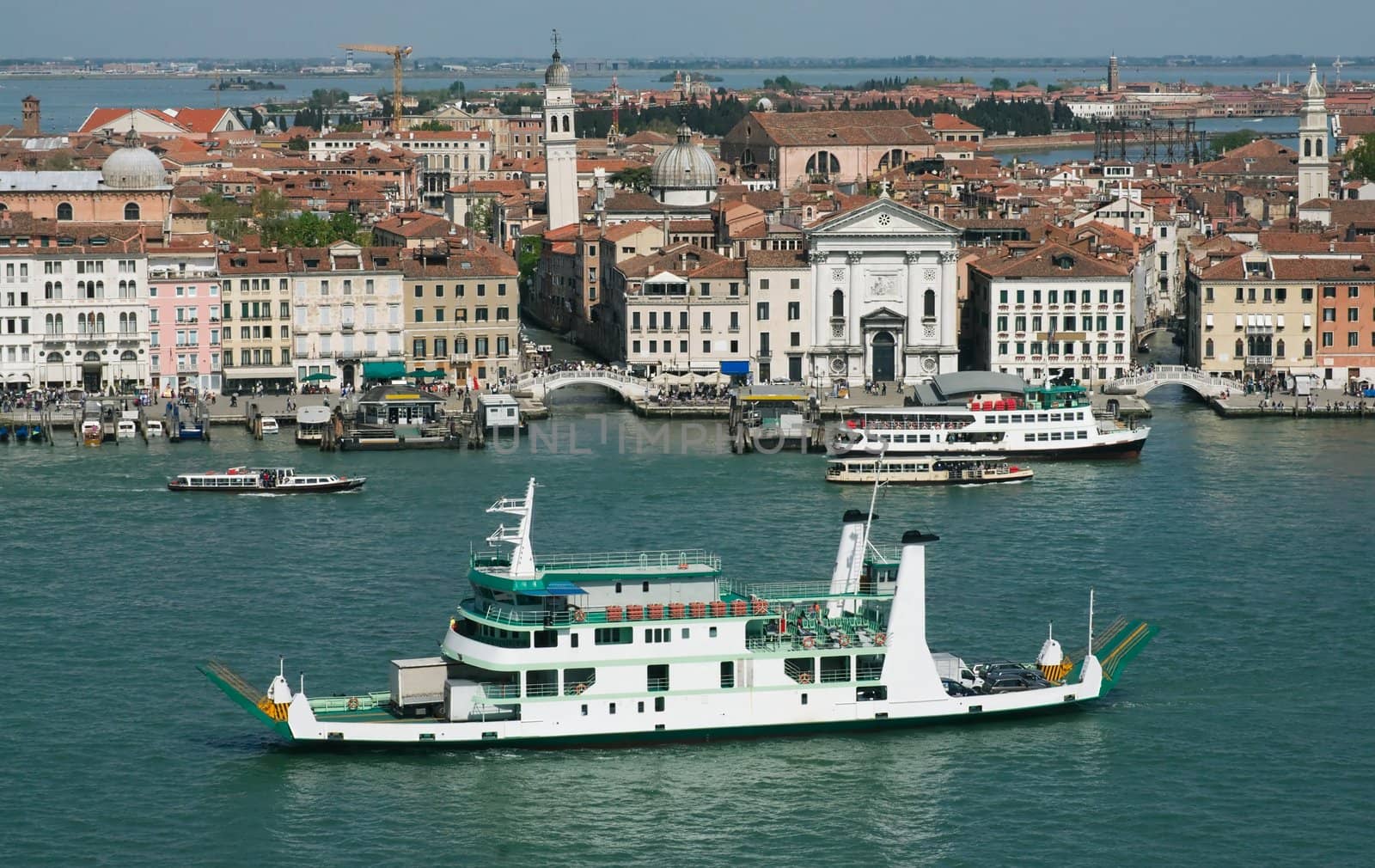 Panorama of Venice with a ferry boat in the foreground