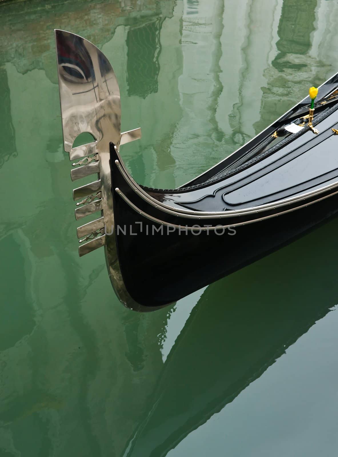Detail of a Venetian gondola and reflection in a channel