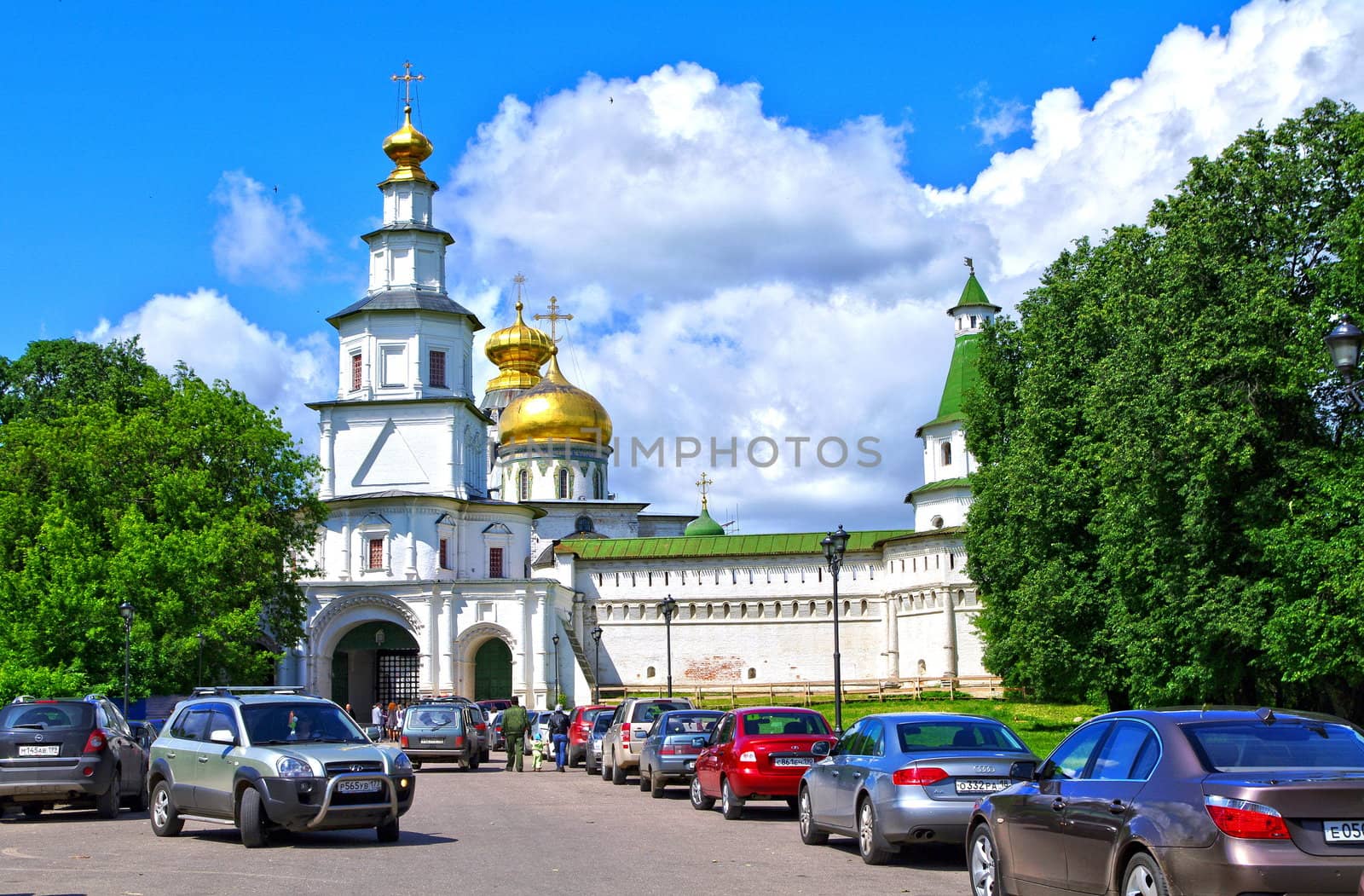 Istra, Russia - June 05, 2010: Summer day. People  walks near the tower of New Jerusalem monastery on June 05, 2010 in Istra, Moscow area, Russia