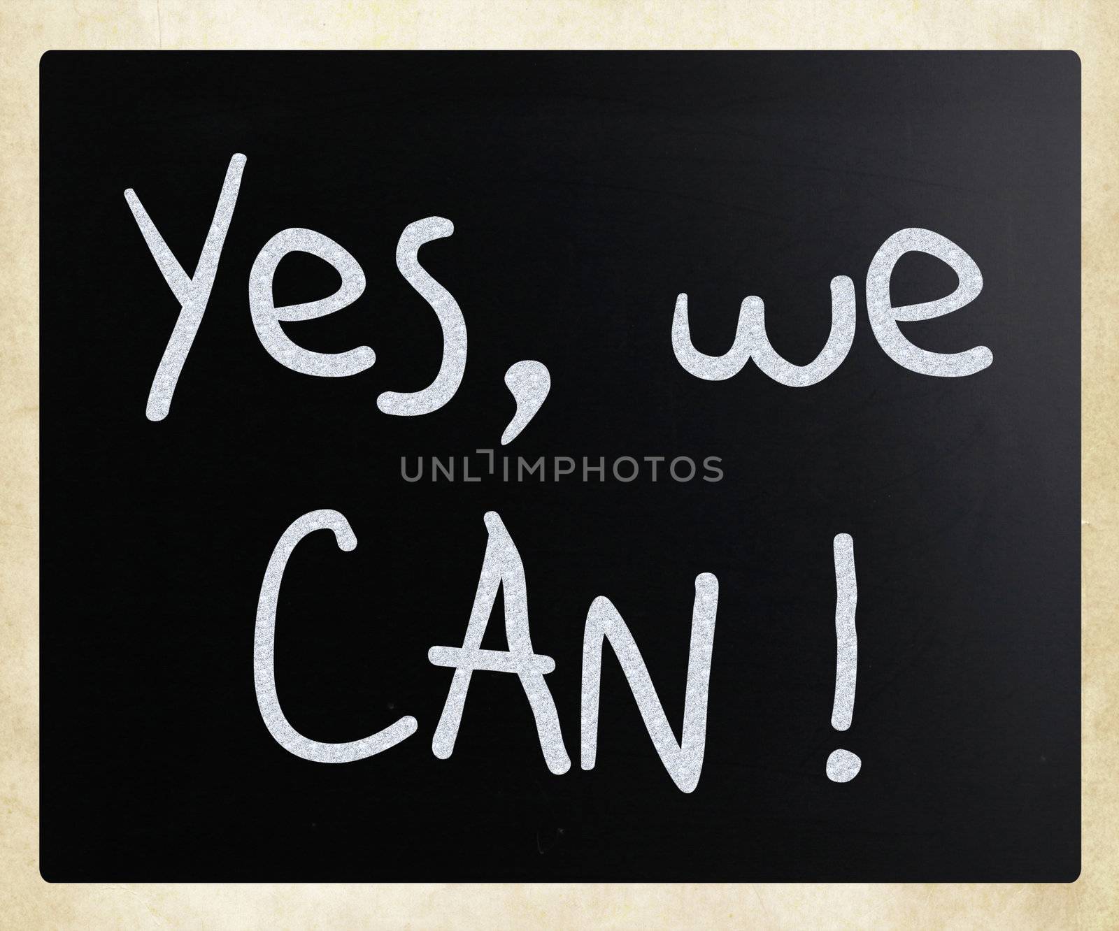 "Yes, we can!" handwritten with white chalk on a blackboard by nenov