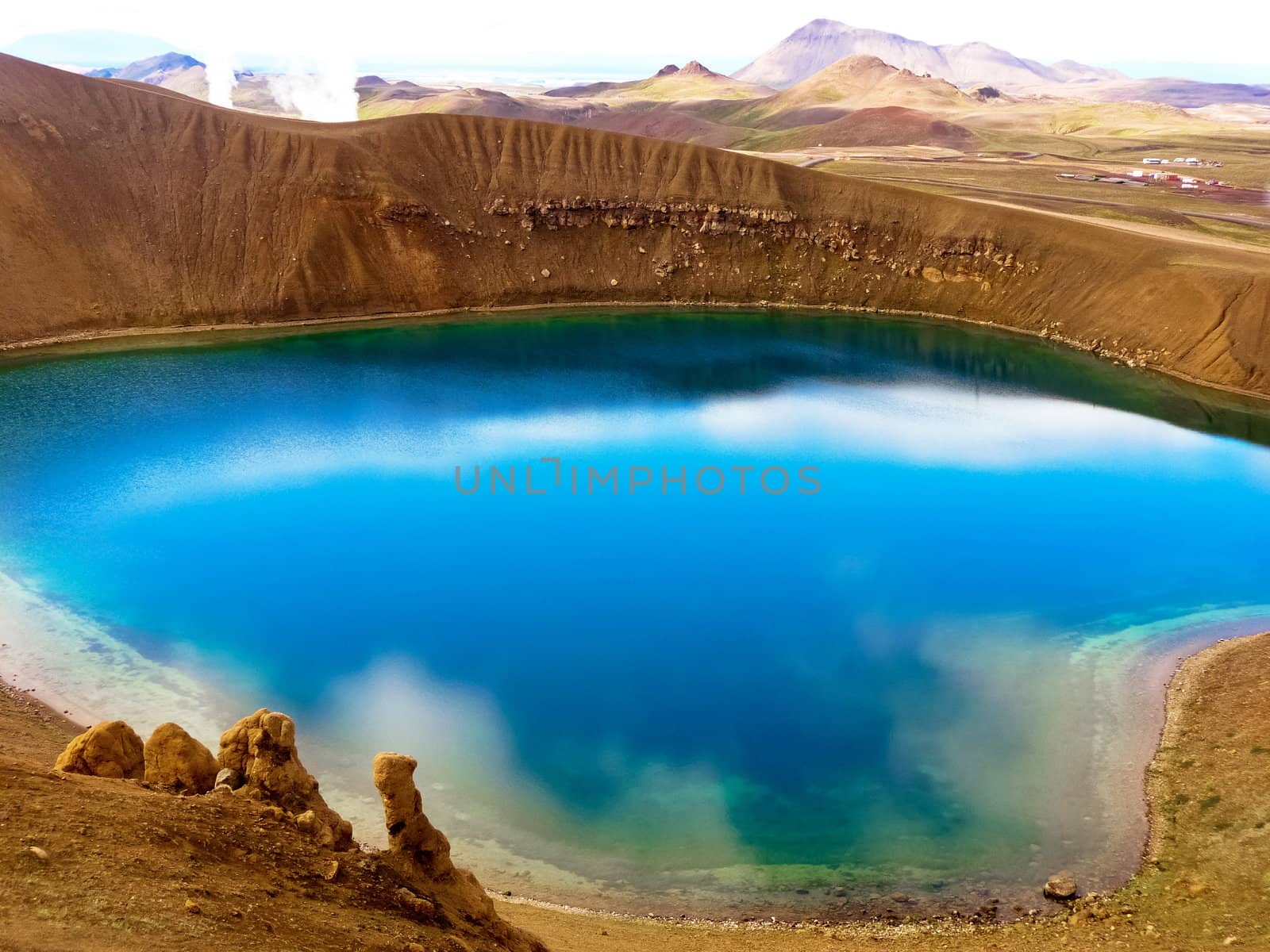 Blue crystal lake with clouds reflected inside