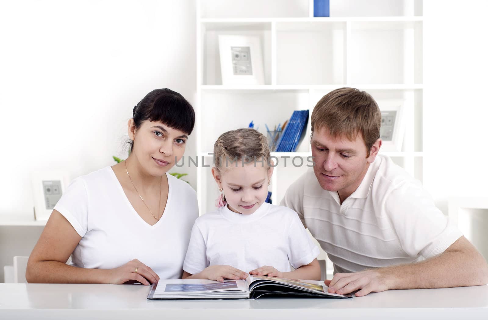 Family reading a book together, a family vacation