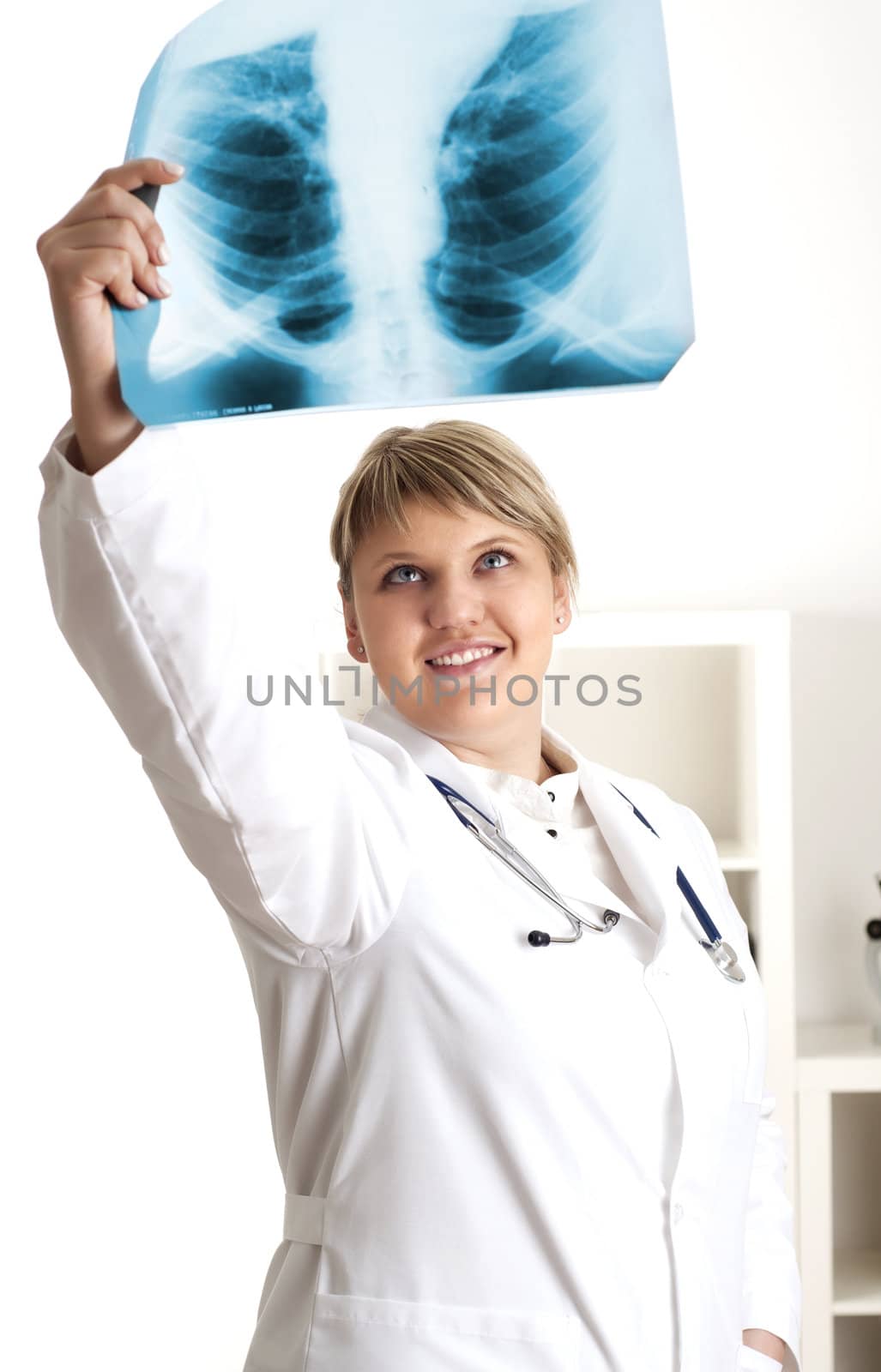 woman doctor looks at x-ray film, smile