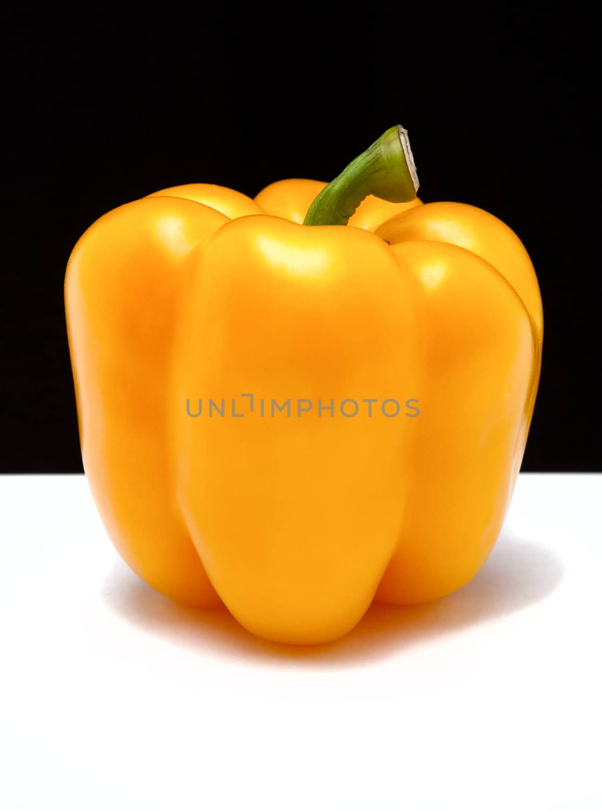 yellow paprika on black and white background isolated