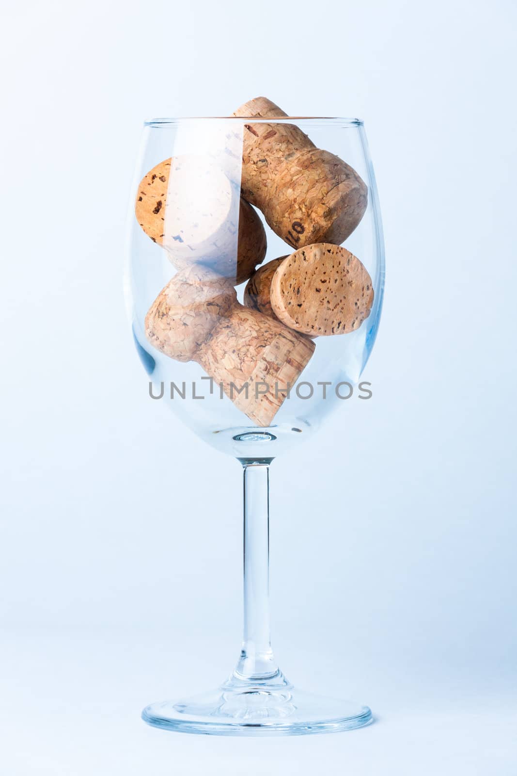 single glass wine with a corks of bottle on white background