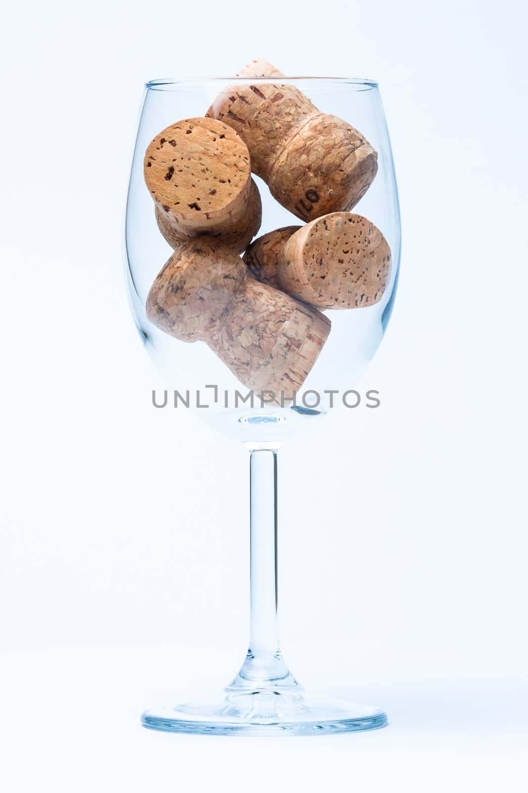 single glass wine with a corks of bottle on white background