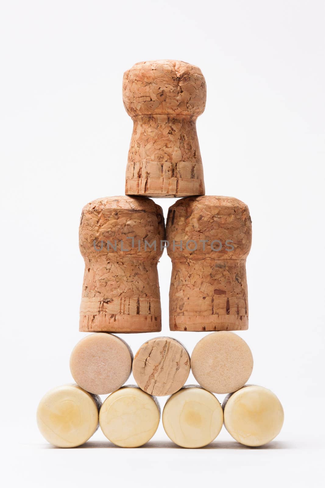 Pyramid made of bottle cork stoppers on white