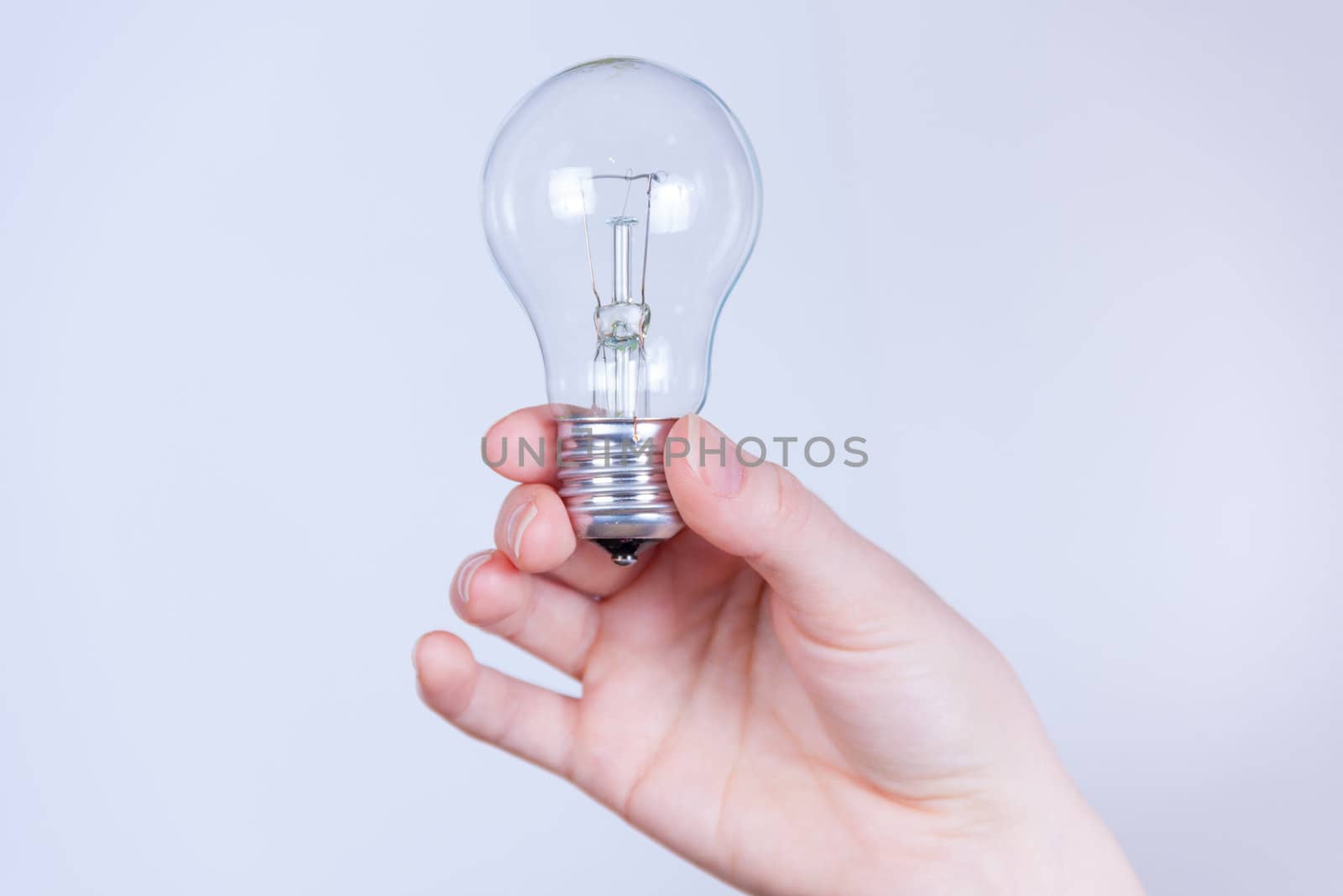 hand holds the electrical lamp by vitmihailov