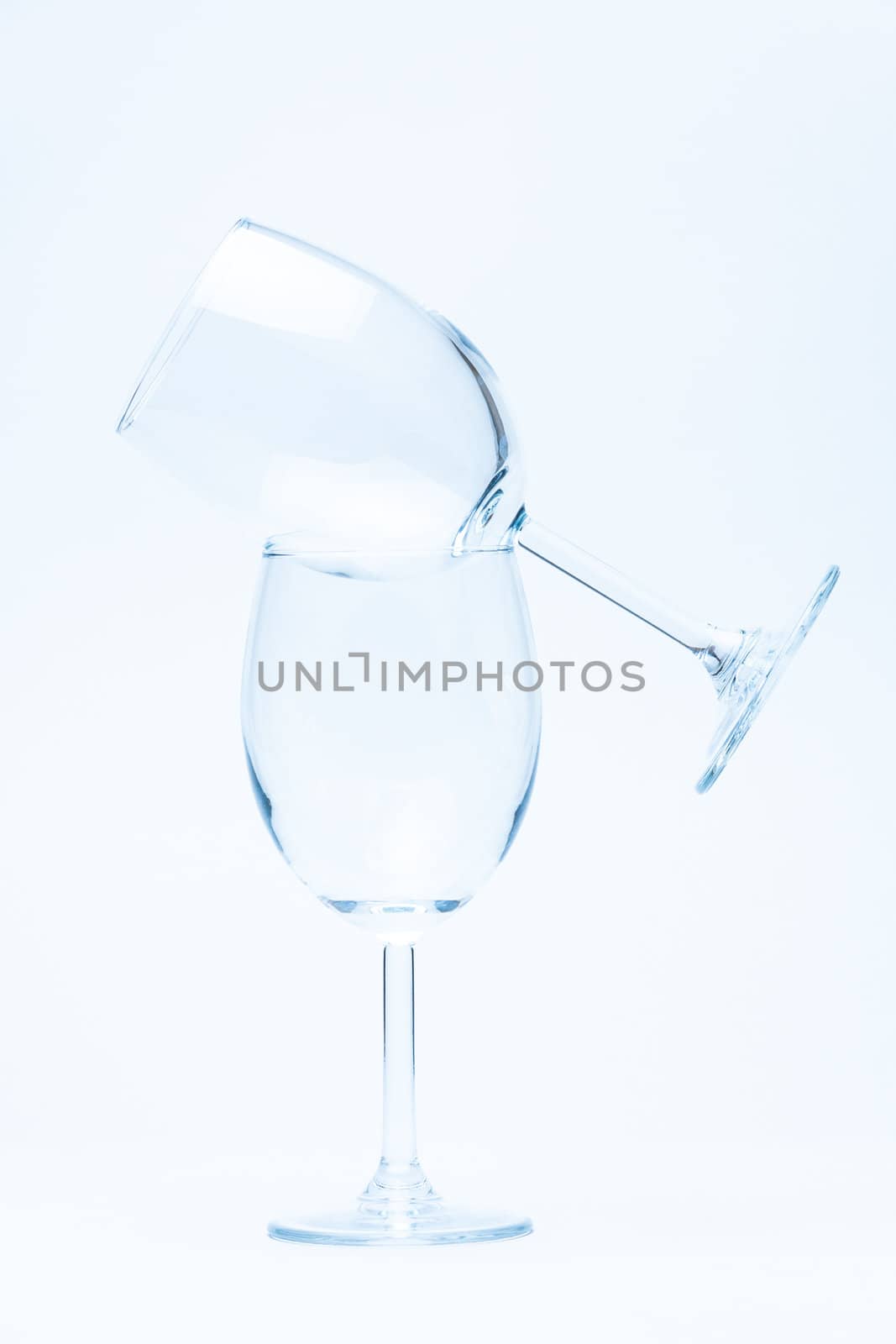 empty wine glass standing on a glass on white