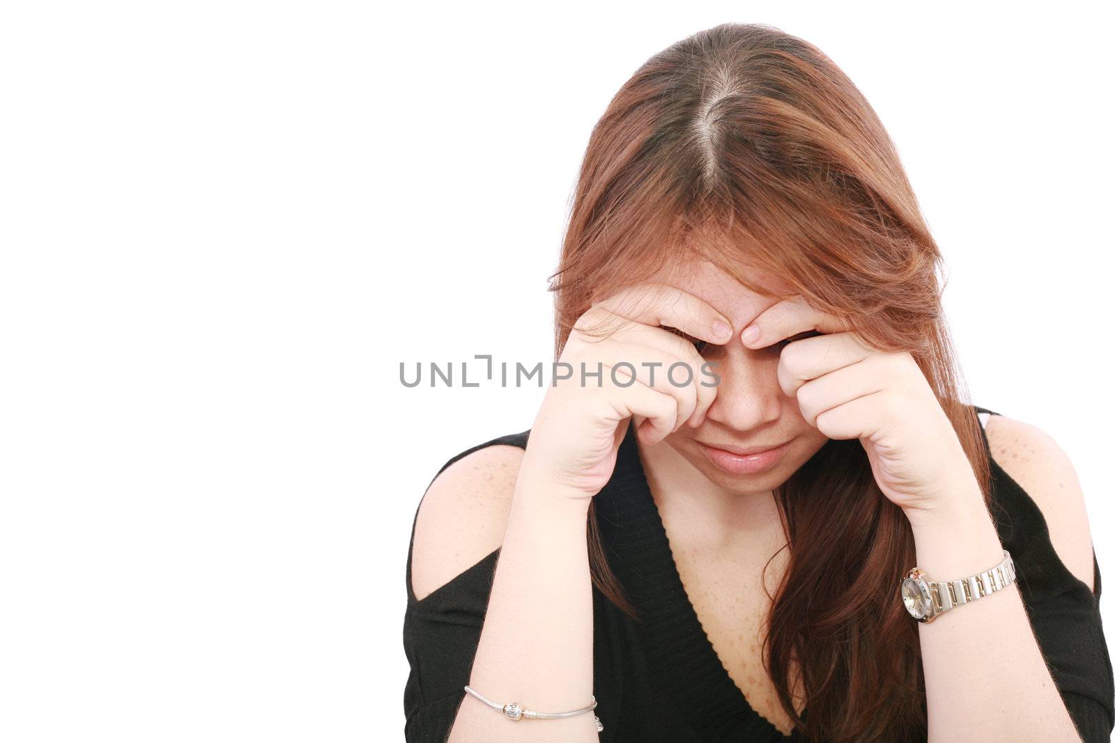 Young business woman looking worried at desk on white background