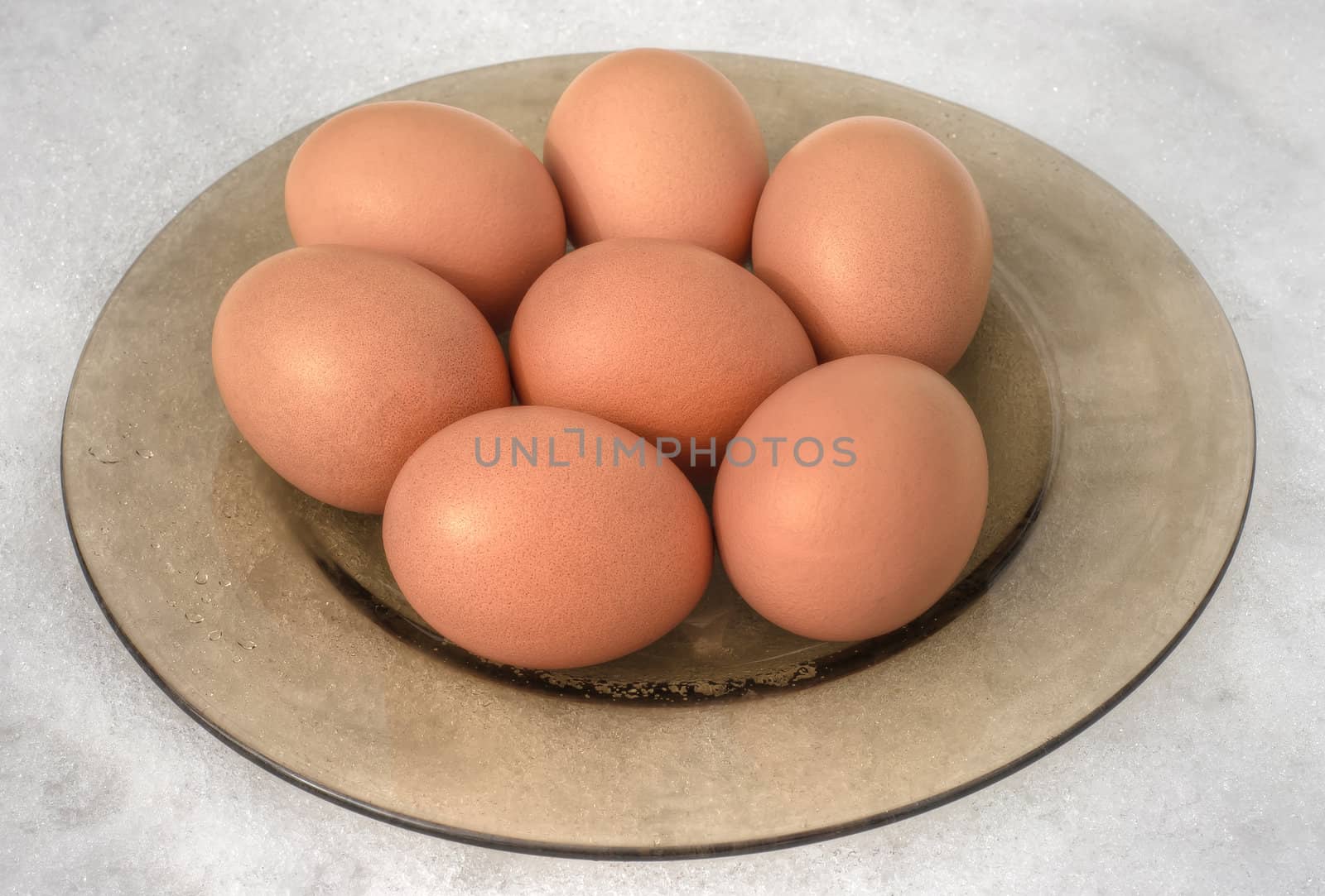 Brown eggs on snow background by photoroman