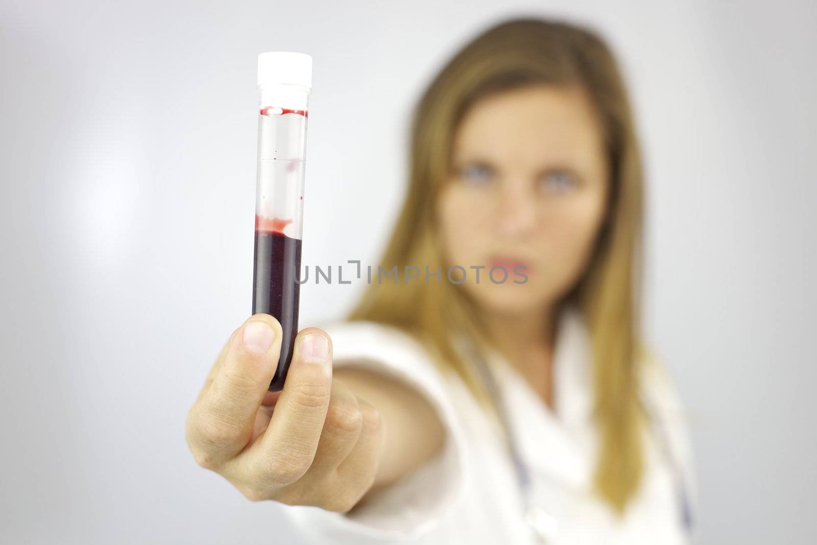 Female doctor with blood sample in hand by fmarsicano