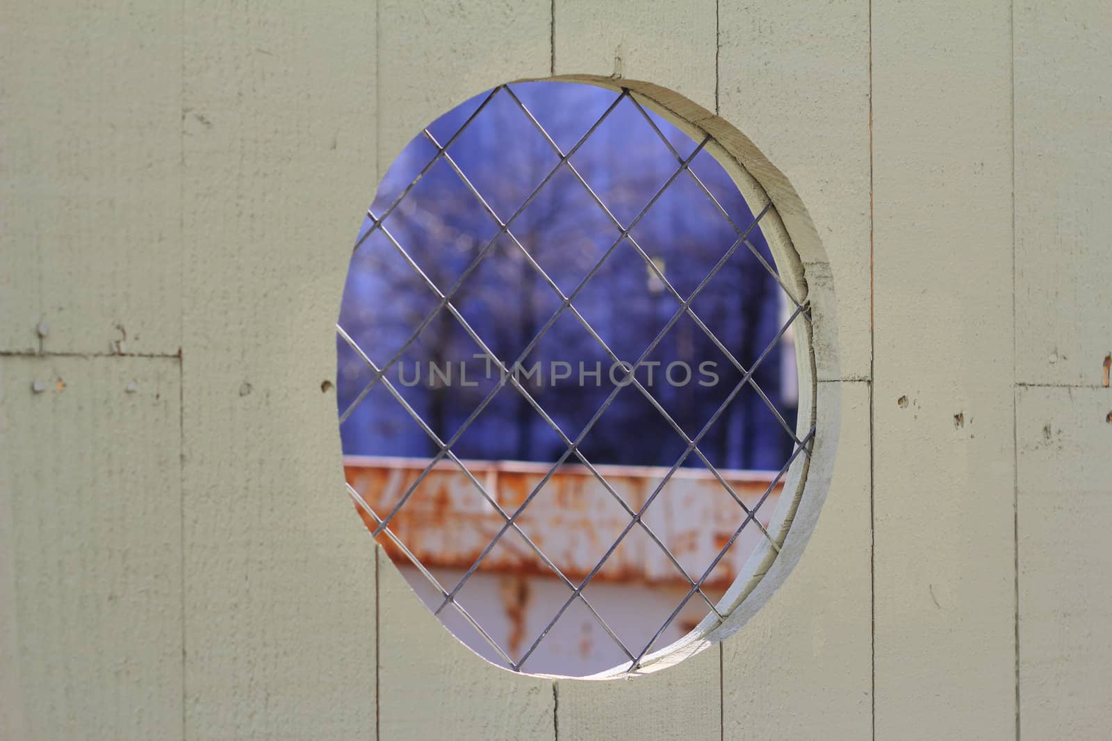 Peephole in a security fence at a construction site.