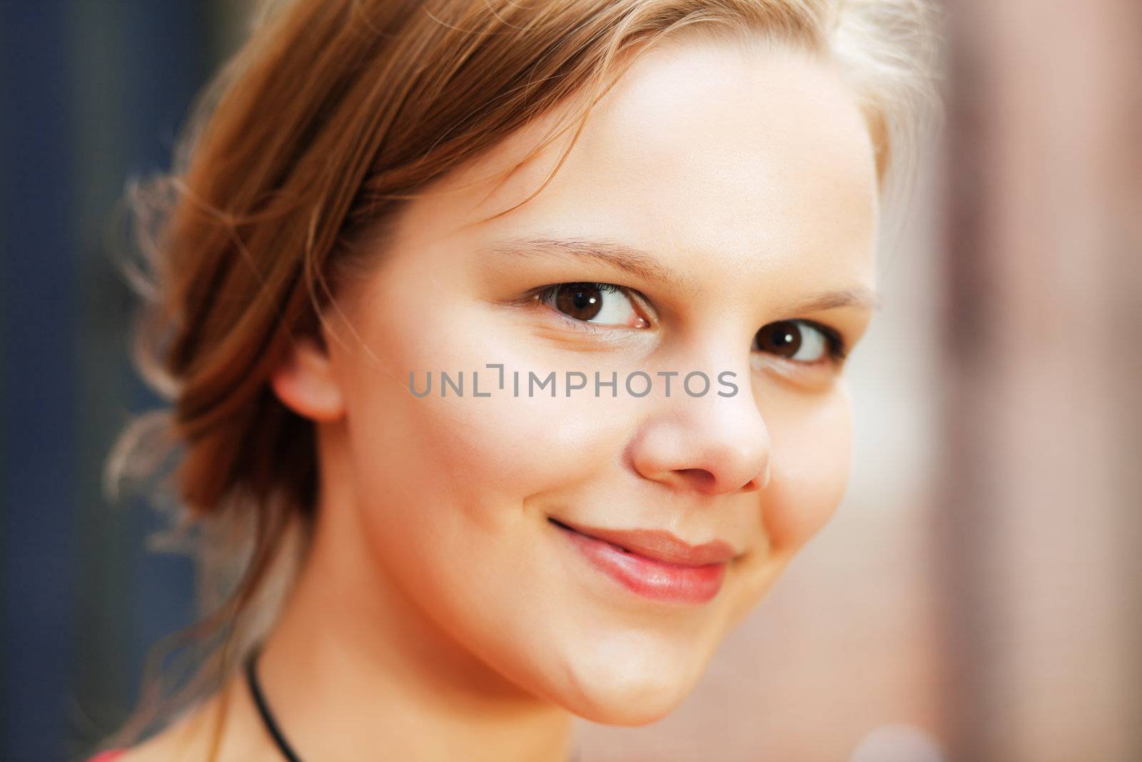 Happy young woman photographed outdoors