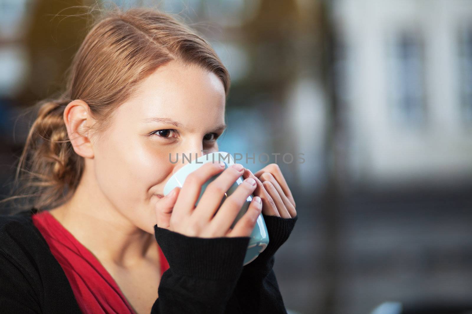 Pretty young woman with cup of chocomilk by MikLav