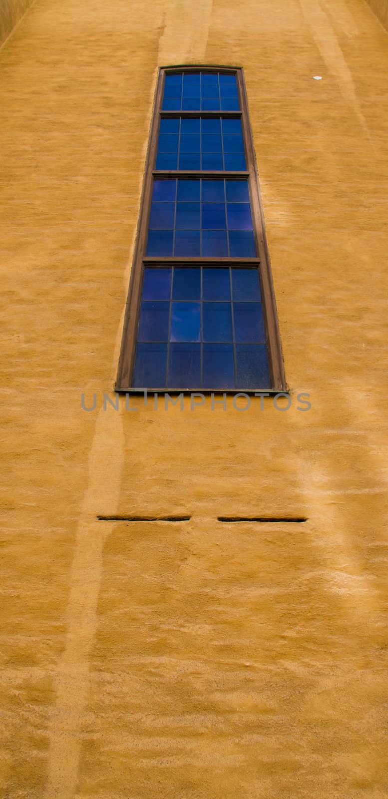 Row of windows on a brown wall