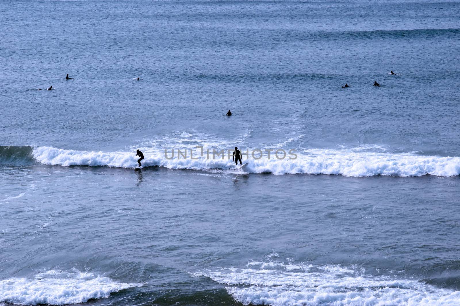 beautiful clean atlantic ocean with surfers catching the waves on Irelands coast