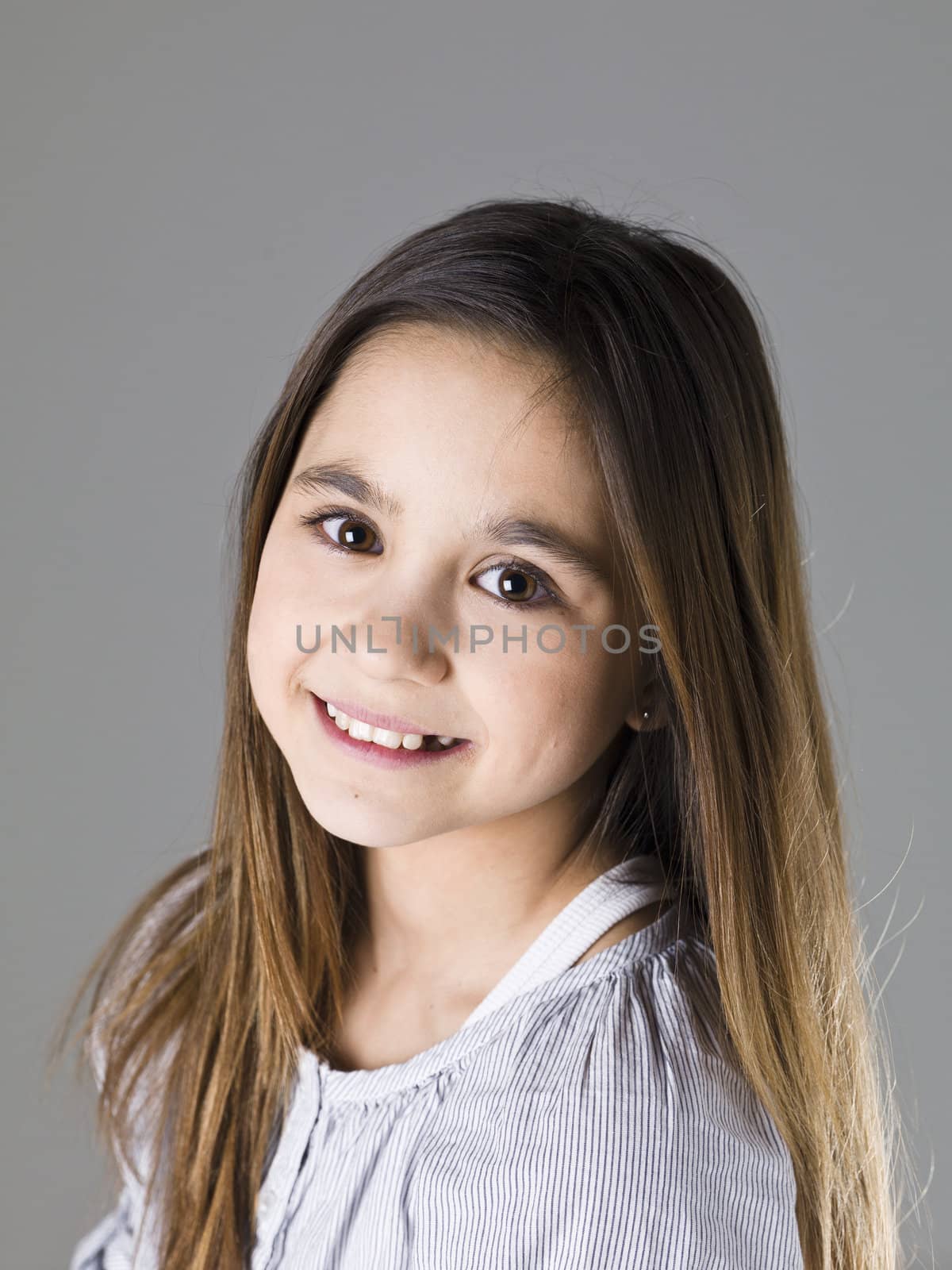 Portrait of a young girl on grey background