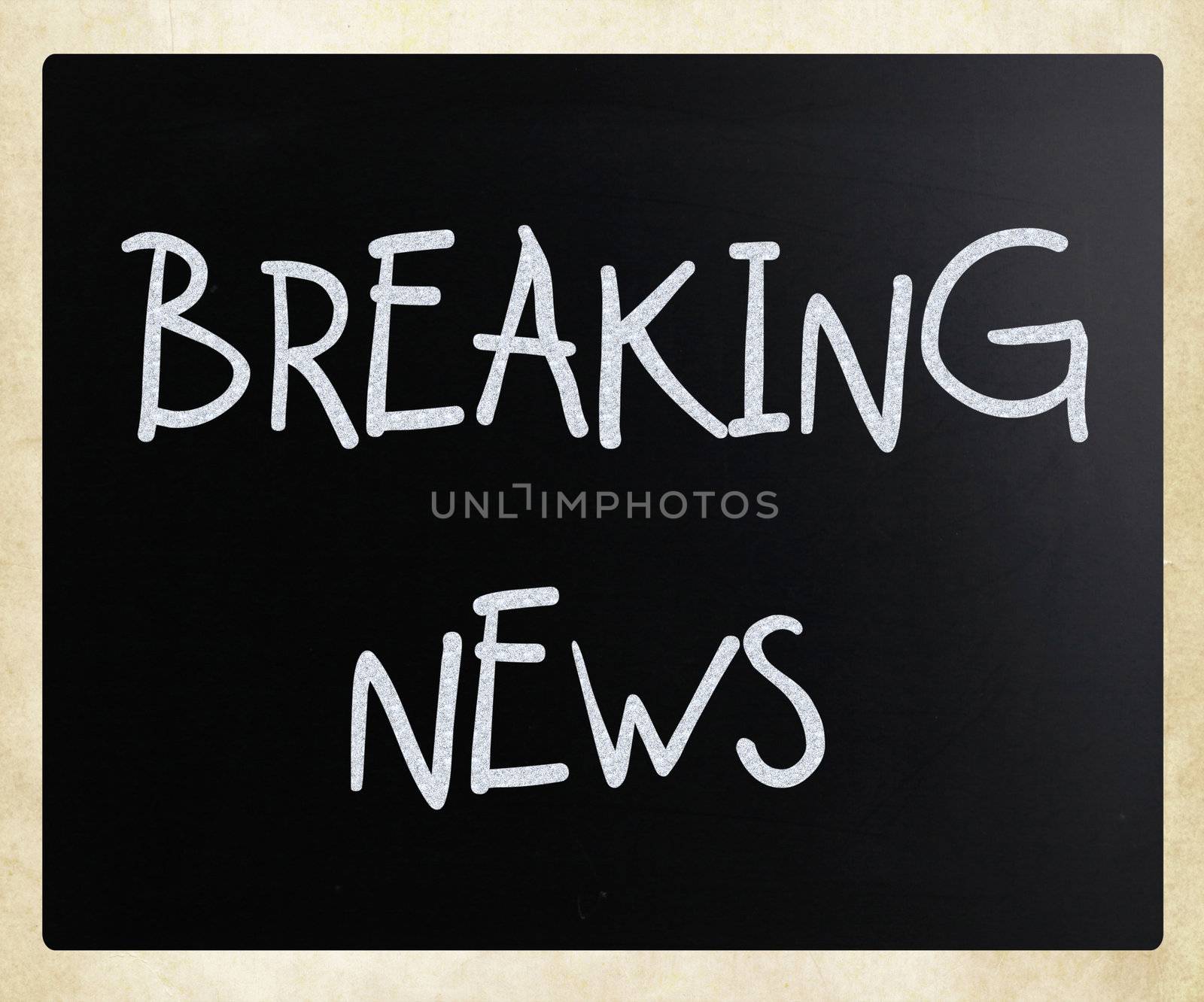 "Breaking news" handwritten with white chalk on a blackboard