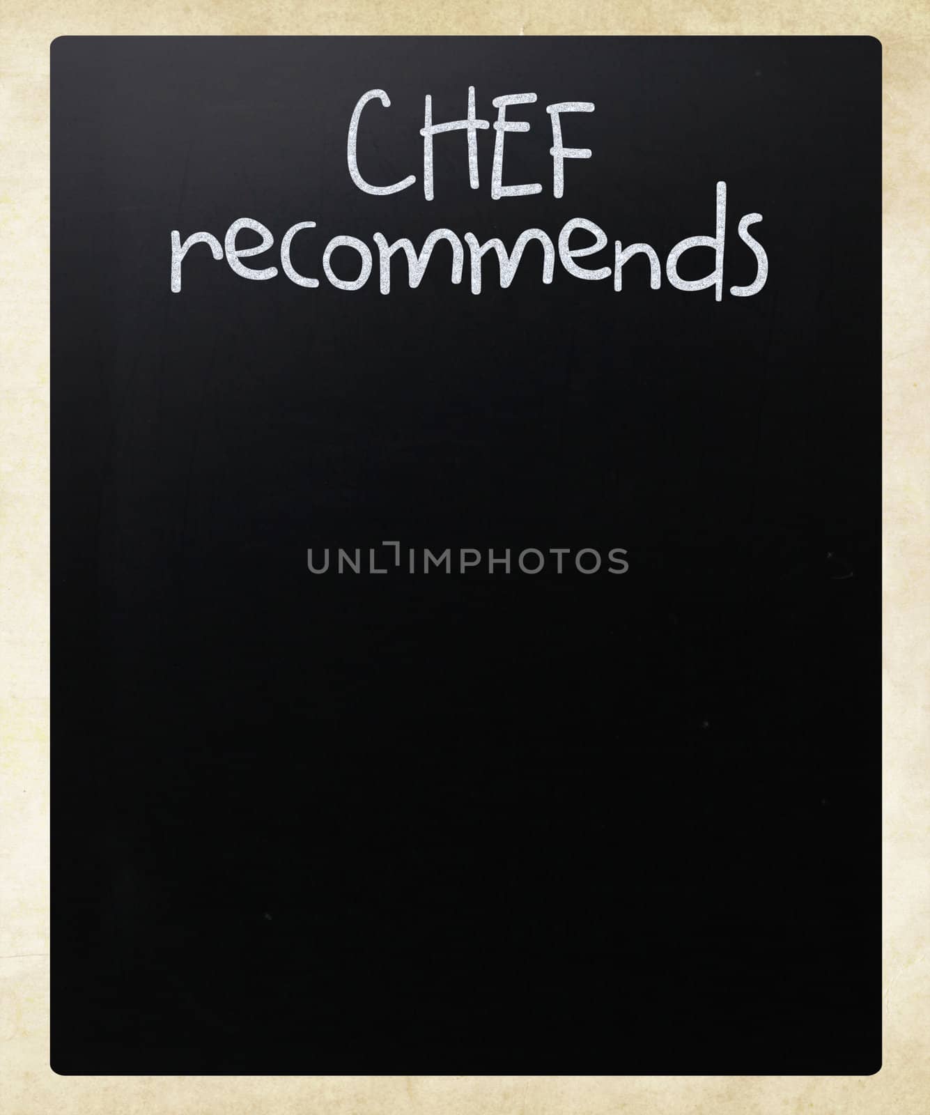 "Chef recommends" handwritten with white chalk on a blackboard