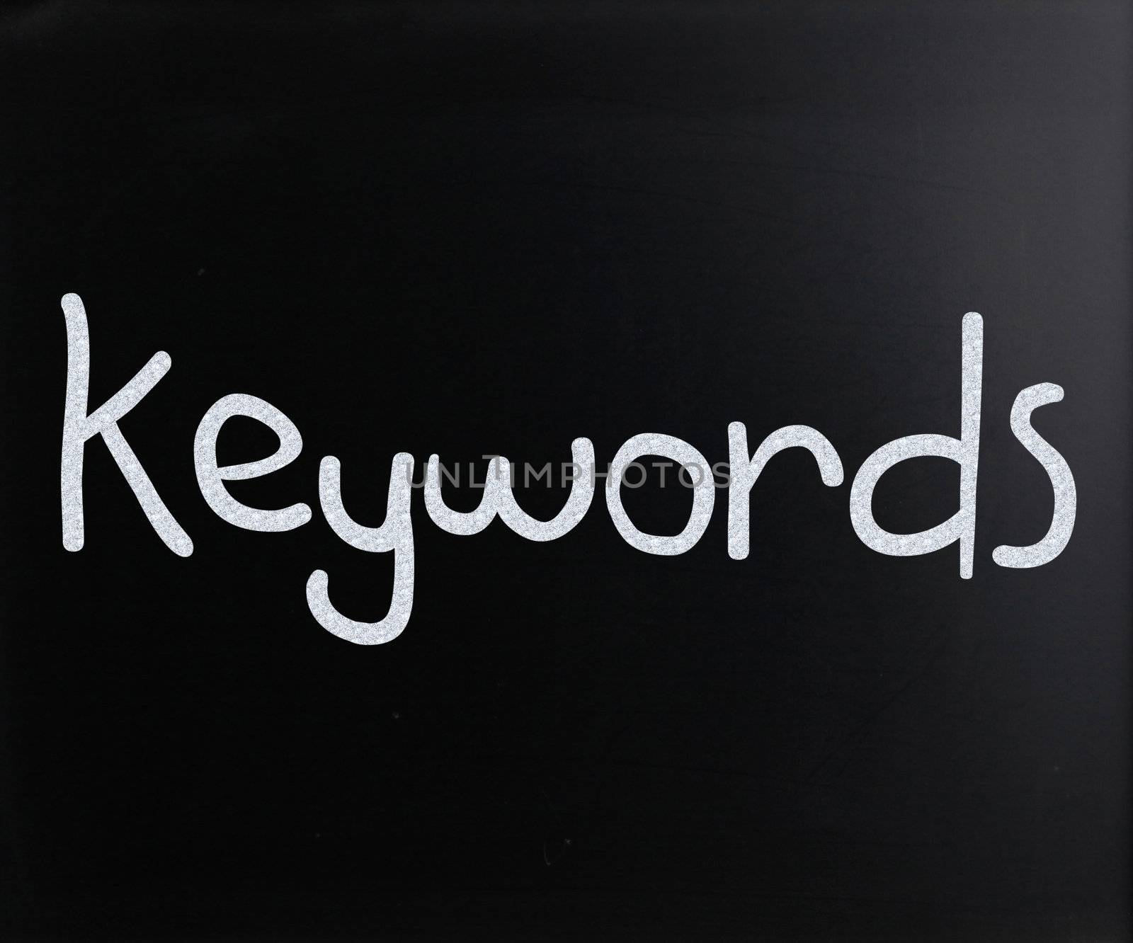 The word "Keywords" handwritten with white chalk on a blackboard