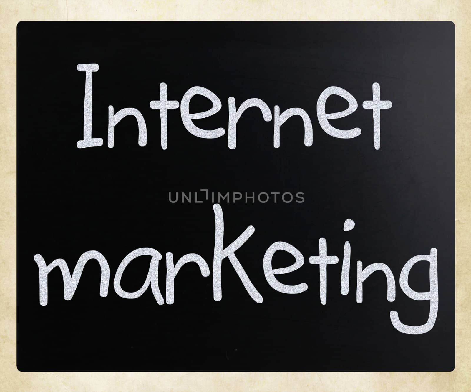 "Internet marketing" handwritten with white chalk on a blackboard