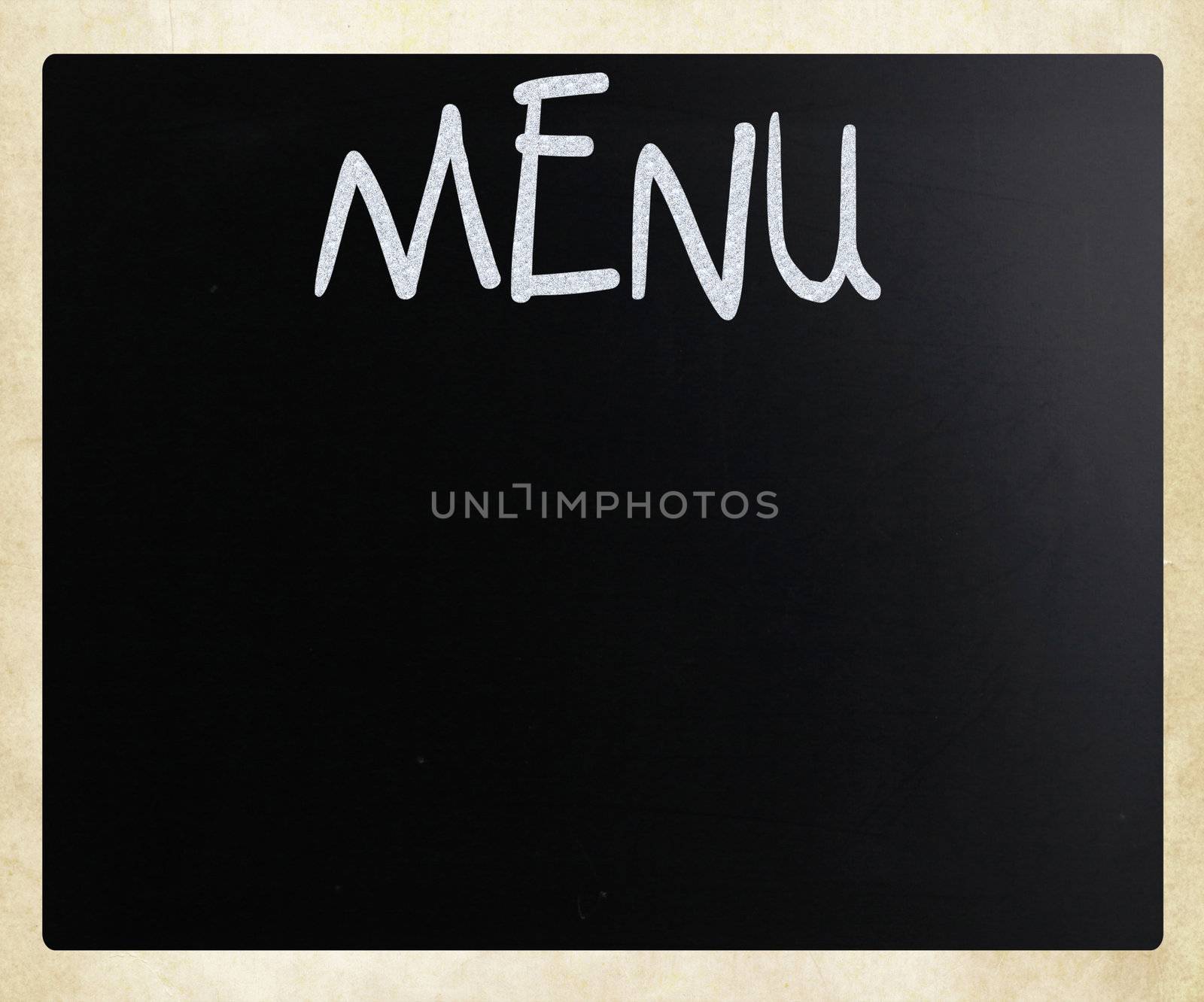 The word "Menu" handwritten with white chalk on a blackboard