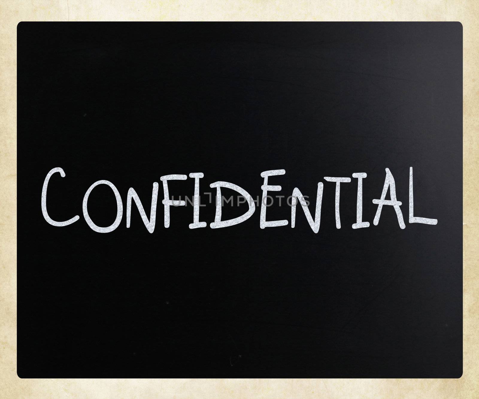 The word "Confidential" handwritten with white chalk on a blackboard