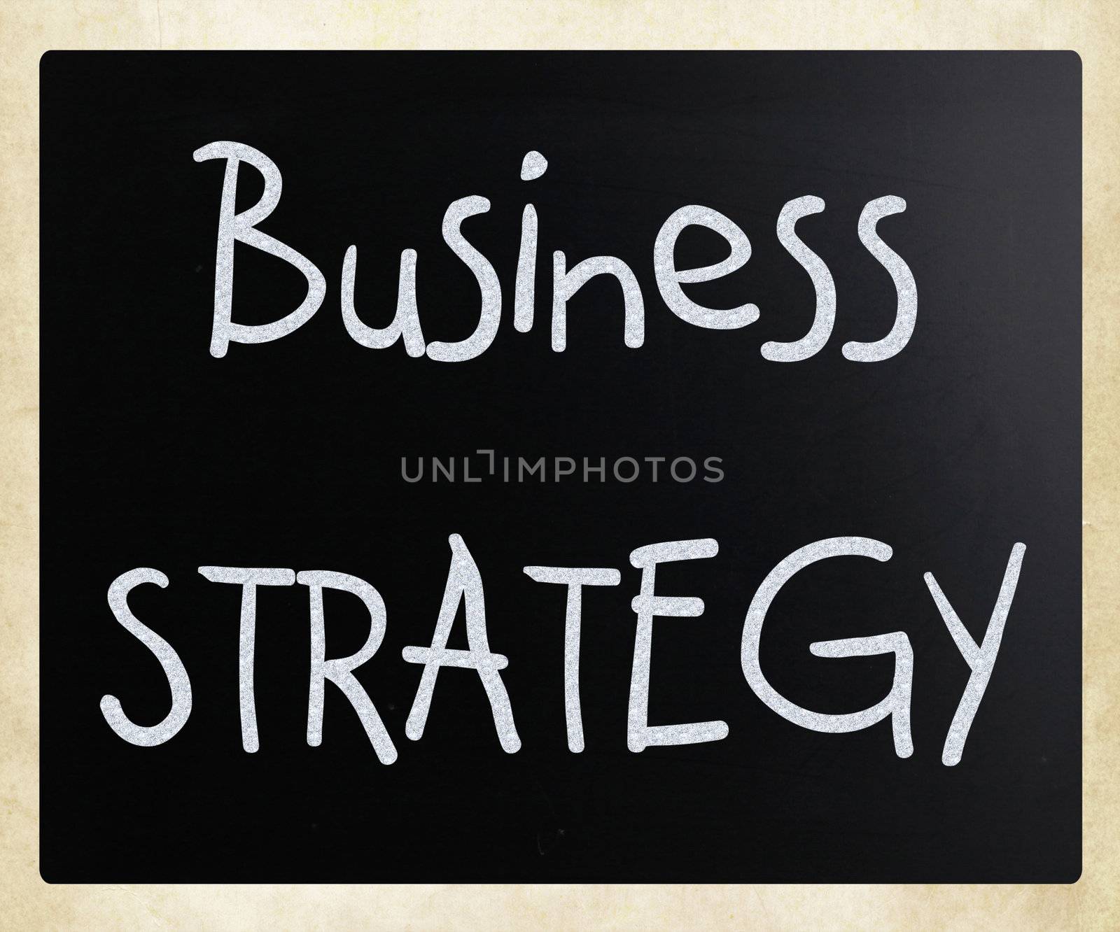 "Business strategy" handwritten with white chalk on a blackboard