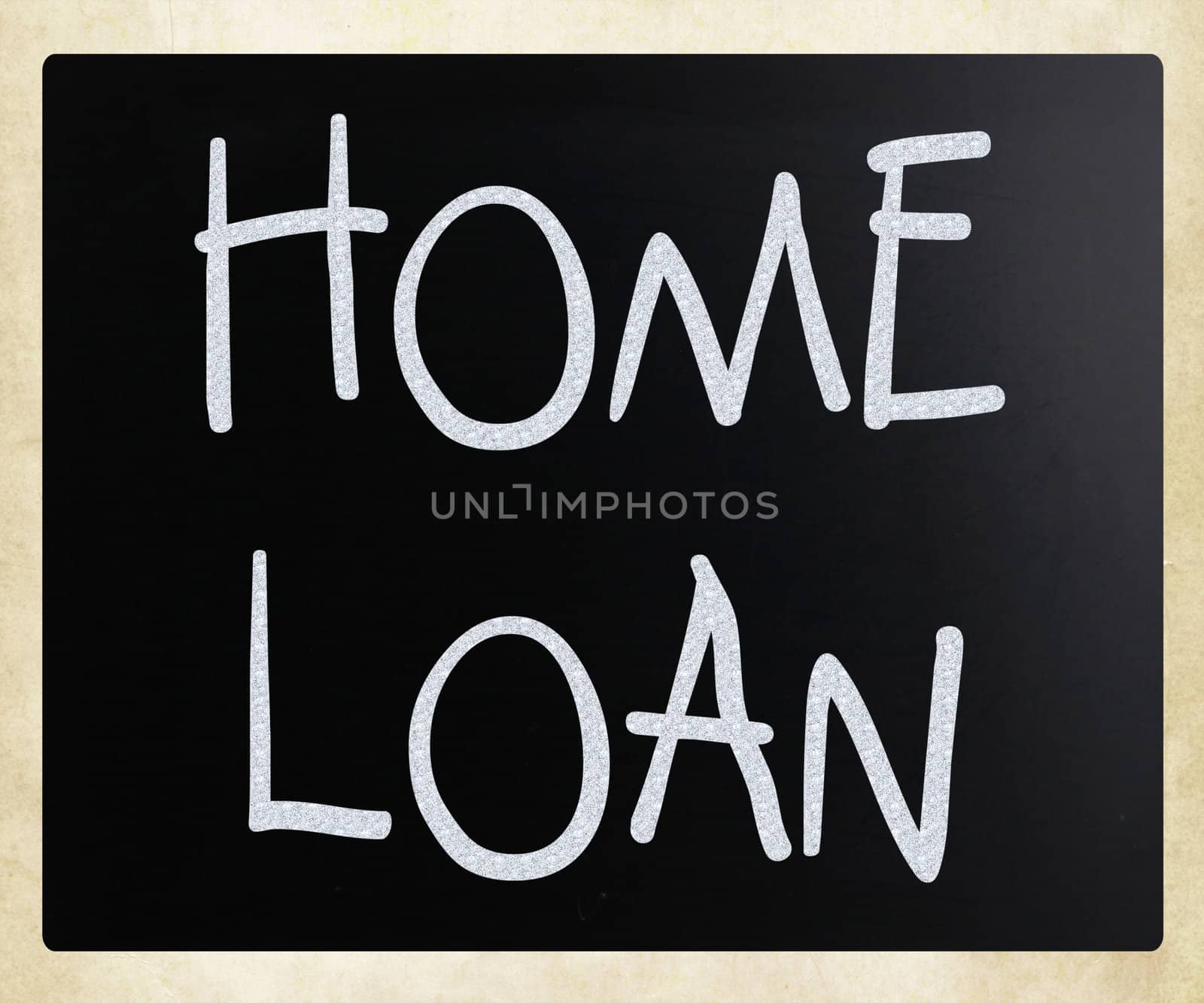 "Home loan" handwritten with white chalk on a blackboard