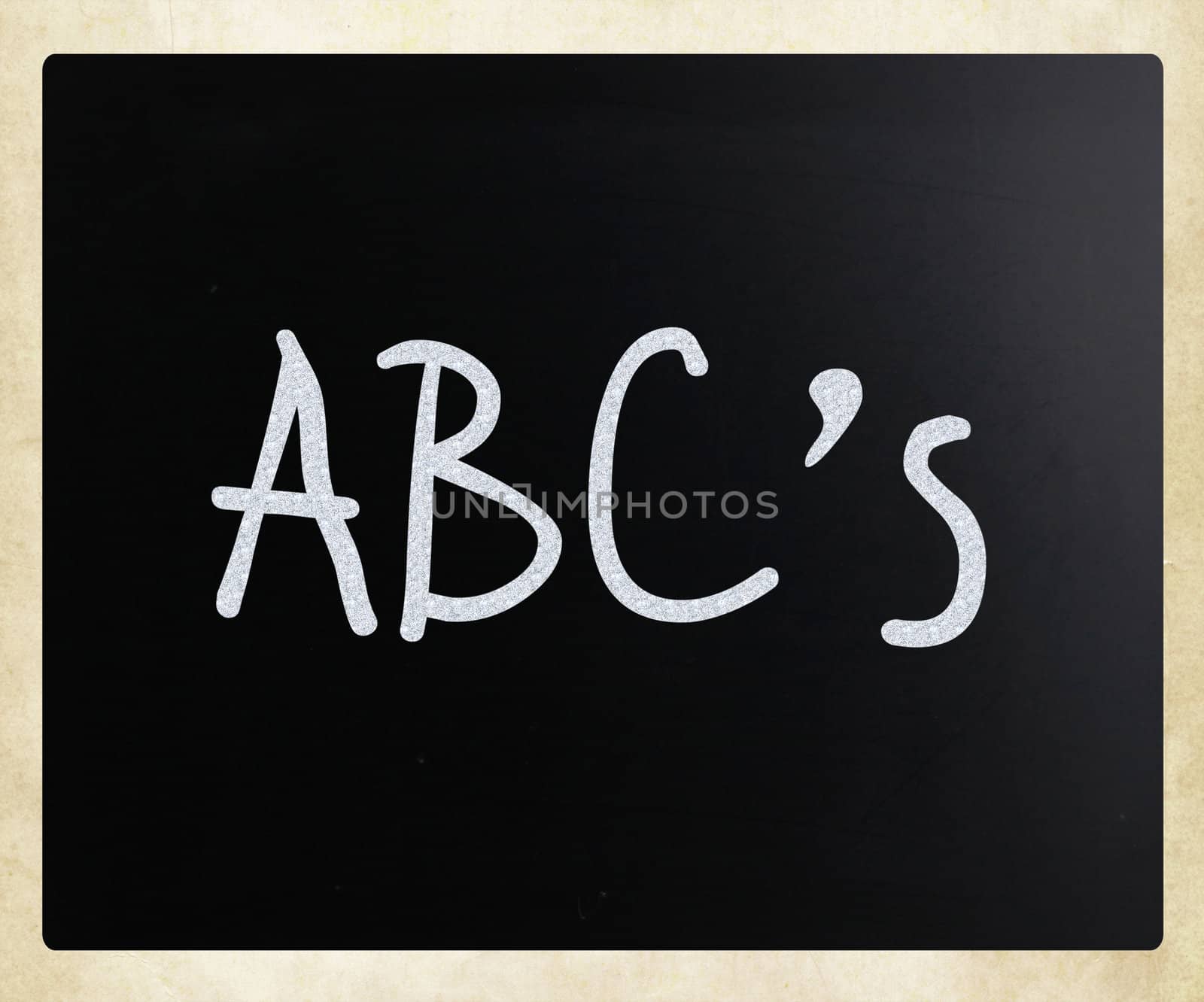 "ABC's" handwritten with white chalk on a blackboard